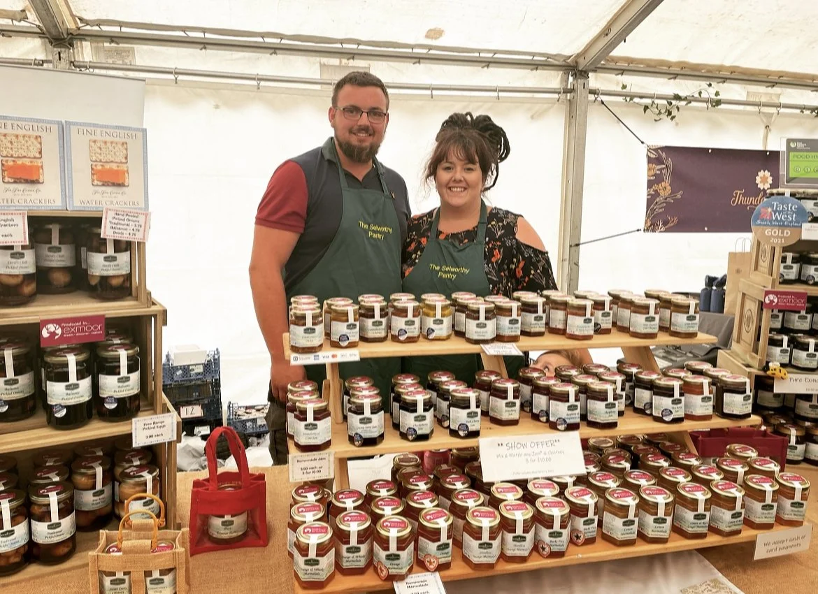 Owners of The Selworthy Pantry, showcasing homemade preserves and Exmoor Honey