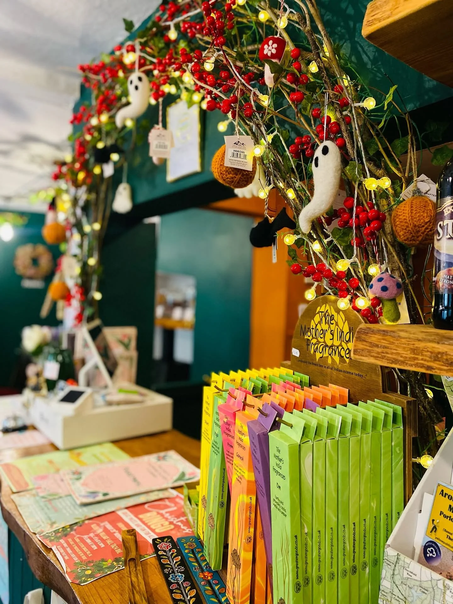 Decorative arch with seasonal decorations for sale including Mother India Incense sticks, sold in Allerford Tea Room, near Minehead, Exmoor