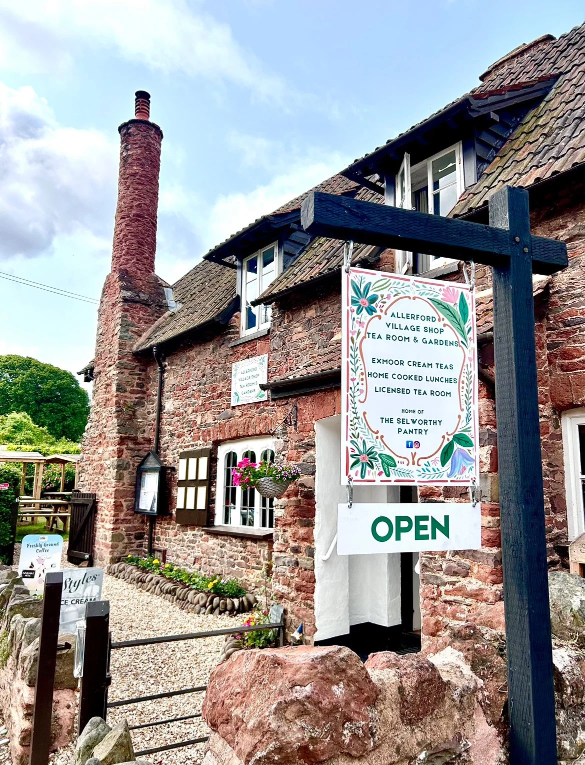 The front of Allerford Tea Room & Gardens, near Minehead, on Exmoor. Sign features home cooked lunches, traditional cream teas, licensed tea room and home of The Selworthy Pantry