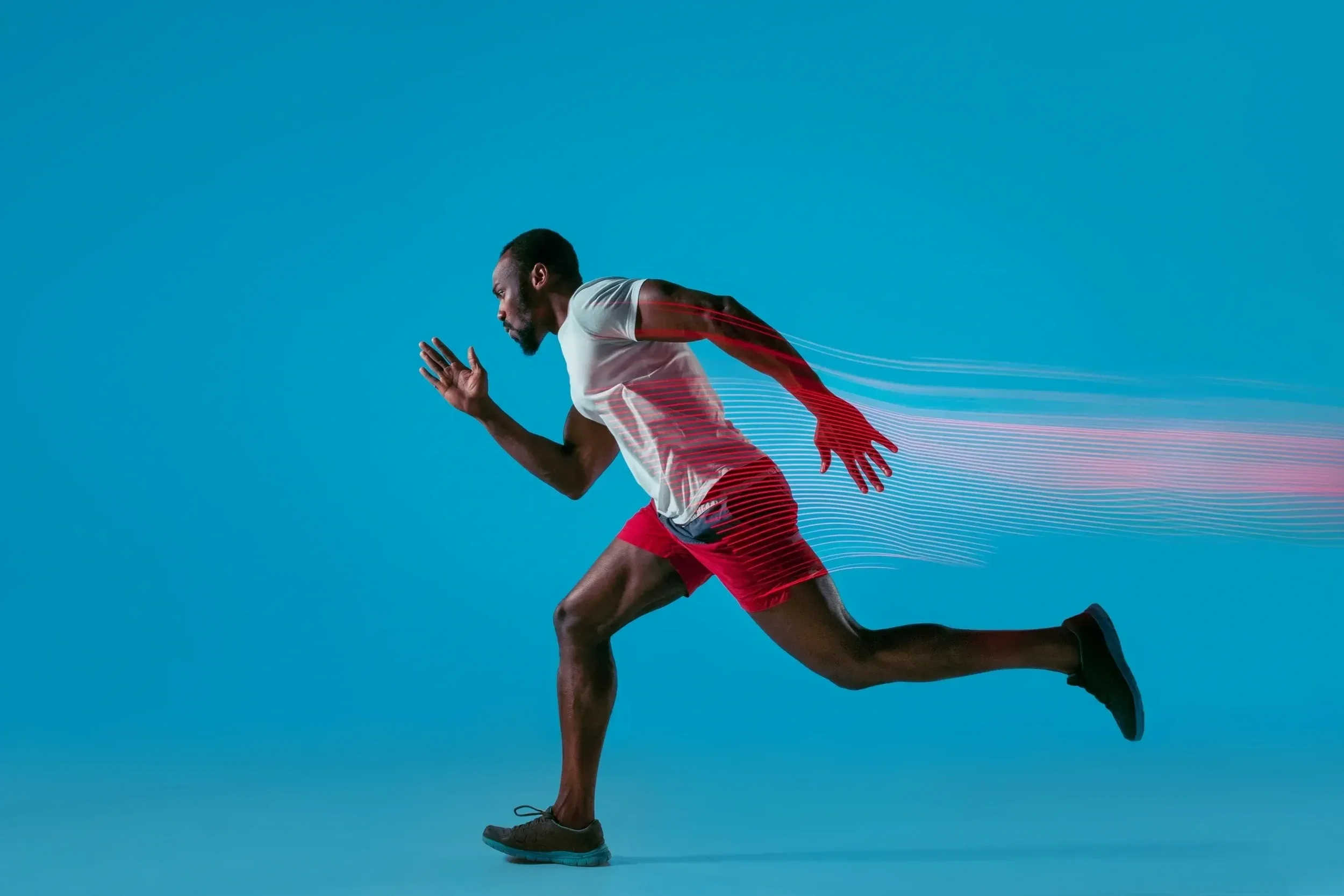 A man in athletic clothing running against a blue background, with motion lines extending from his back.