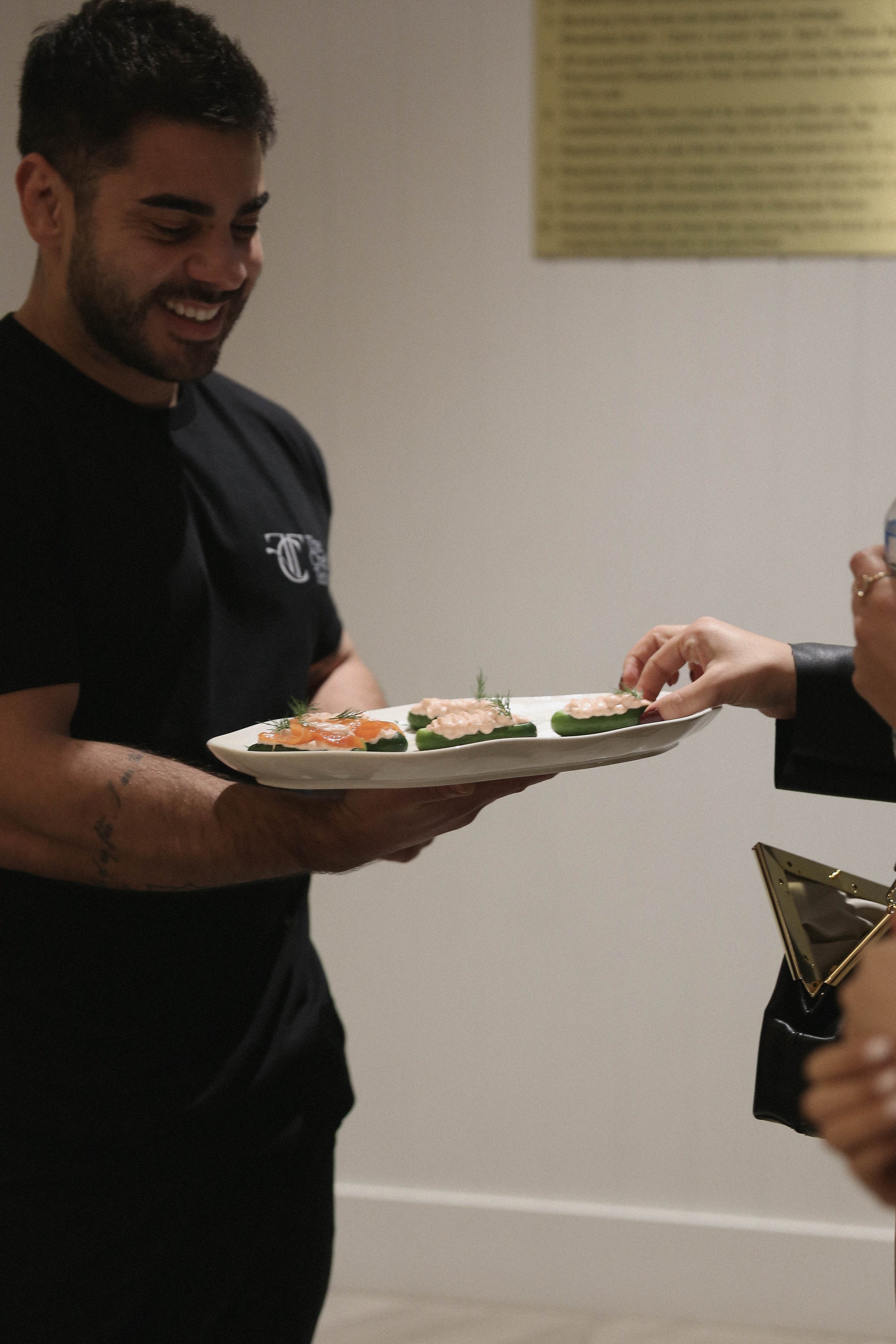 Private chef serving gourmet canapés in Melbourne for a catered event.
