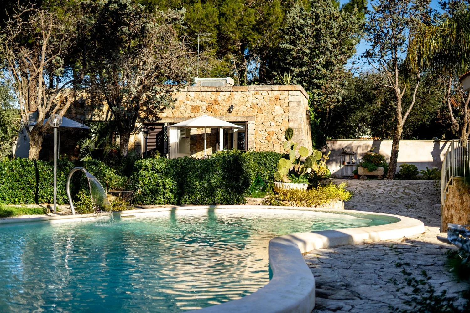 Pool und Steinhaus im Garten der Villa
