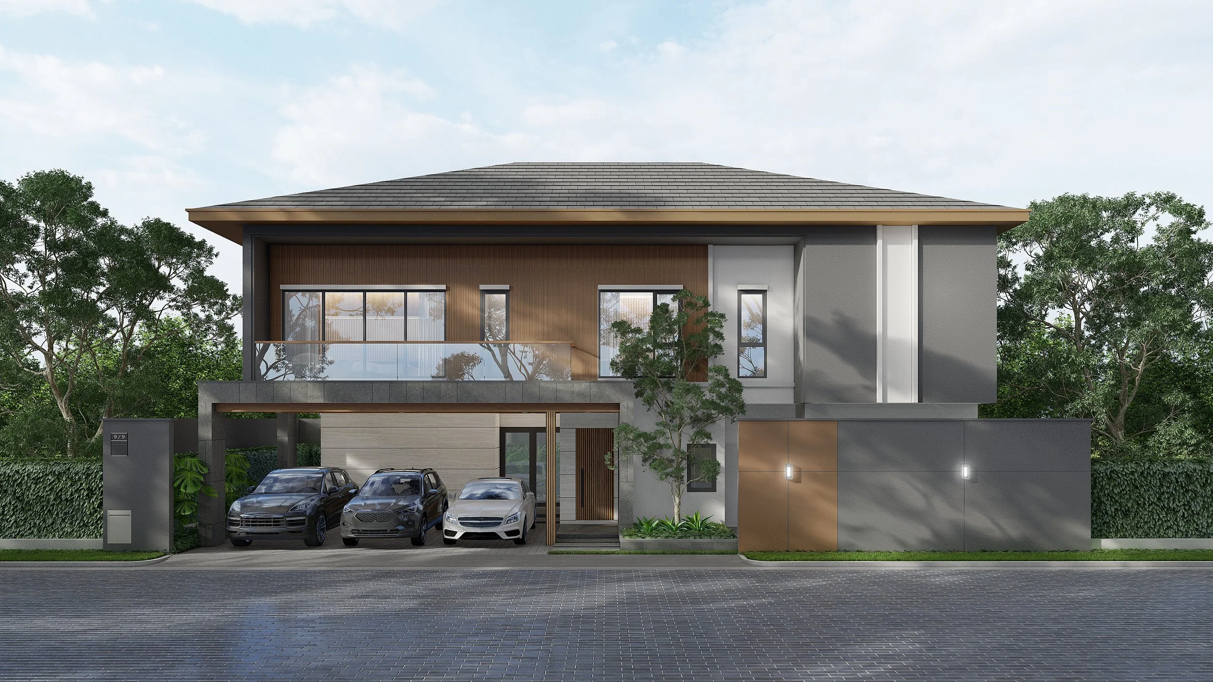 Modern two-story house with a gray exterior, wooden accents, and a balcony, featuring a driveway with three cars and surrounded by greenery.