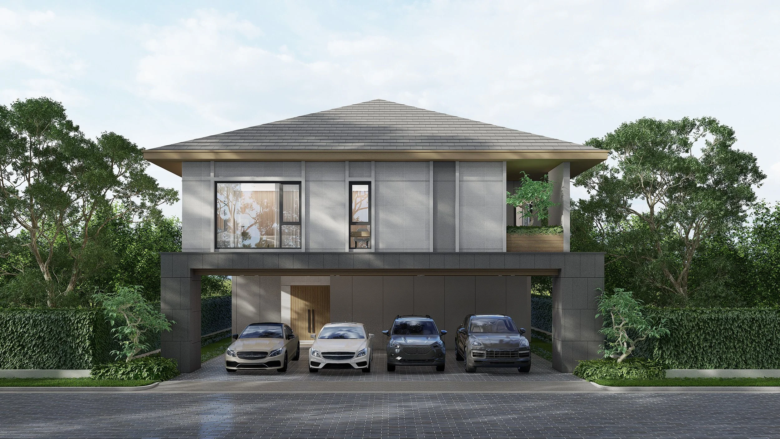 Modern two-story house with a parking garage underneath, four cars parked outside, surrounded by green trees and shrubs, with a tiled driveway and cloudy sky.