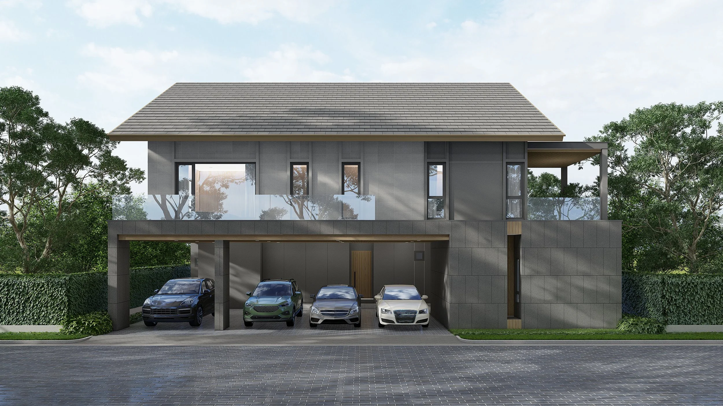 Modern two-story house with a gray exterior, large windows, a sloped roof, a balcony with glass railing, and a garage with four parked cars in front. Green trees and a hedge surround the house.