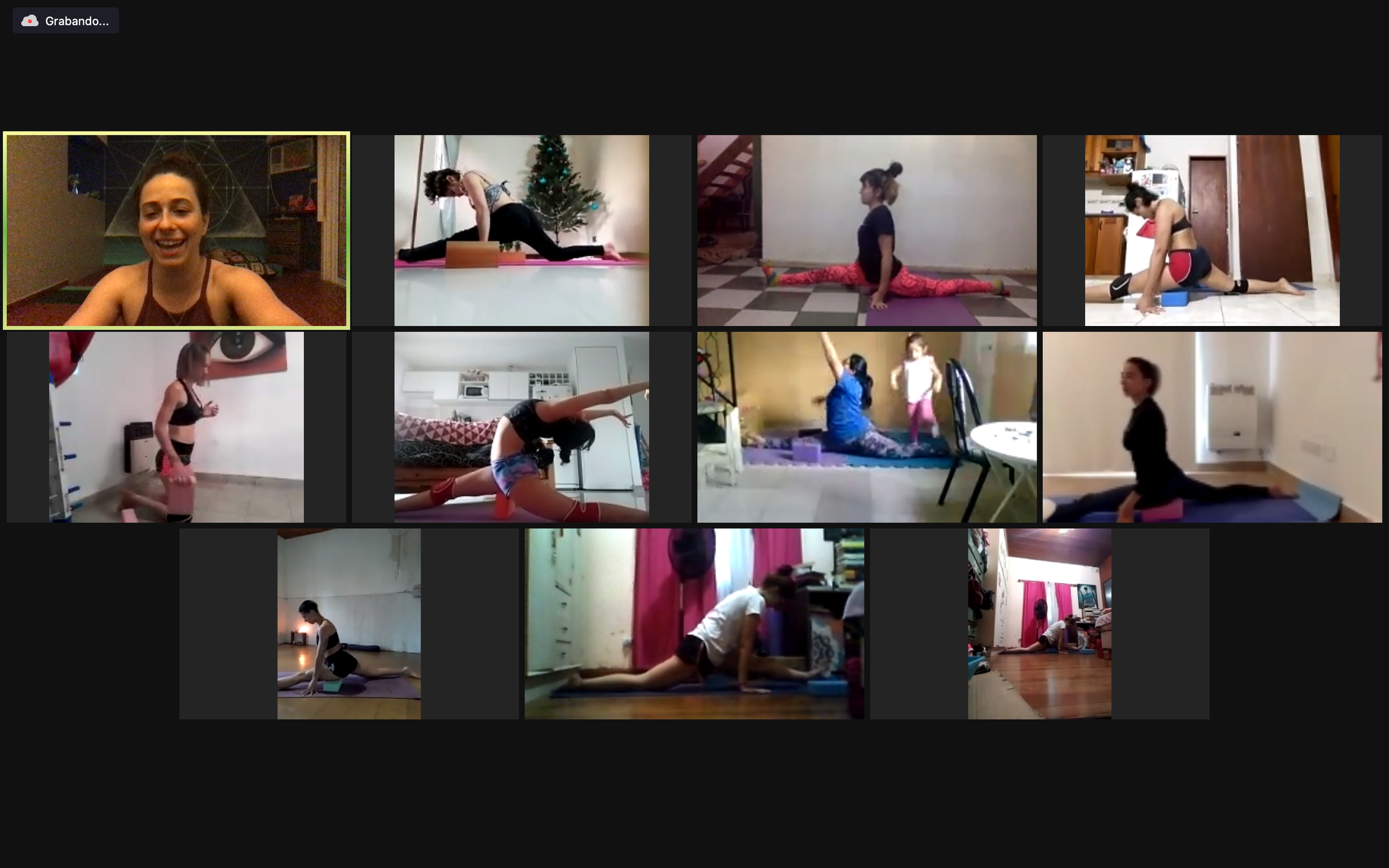 Screenshot of a virtual yoga class or flexibility class or stretching class with multiple participants in different home settings, all practicing yoga, led by an instructor.