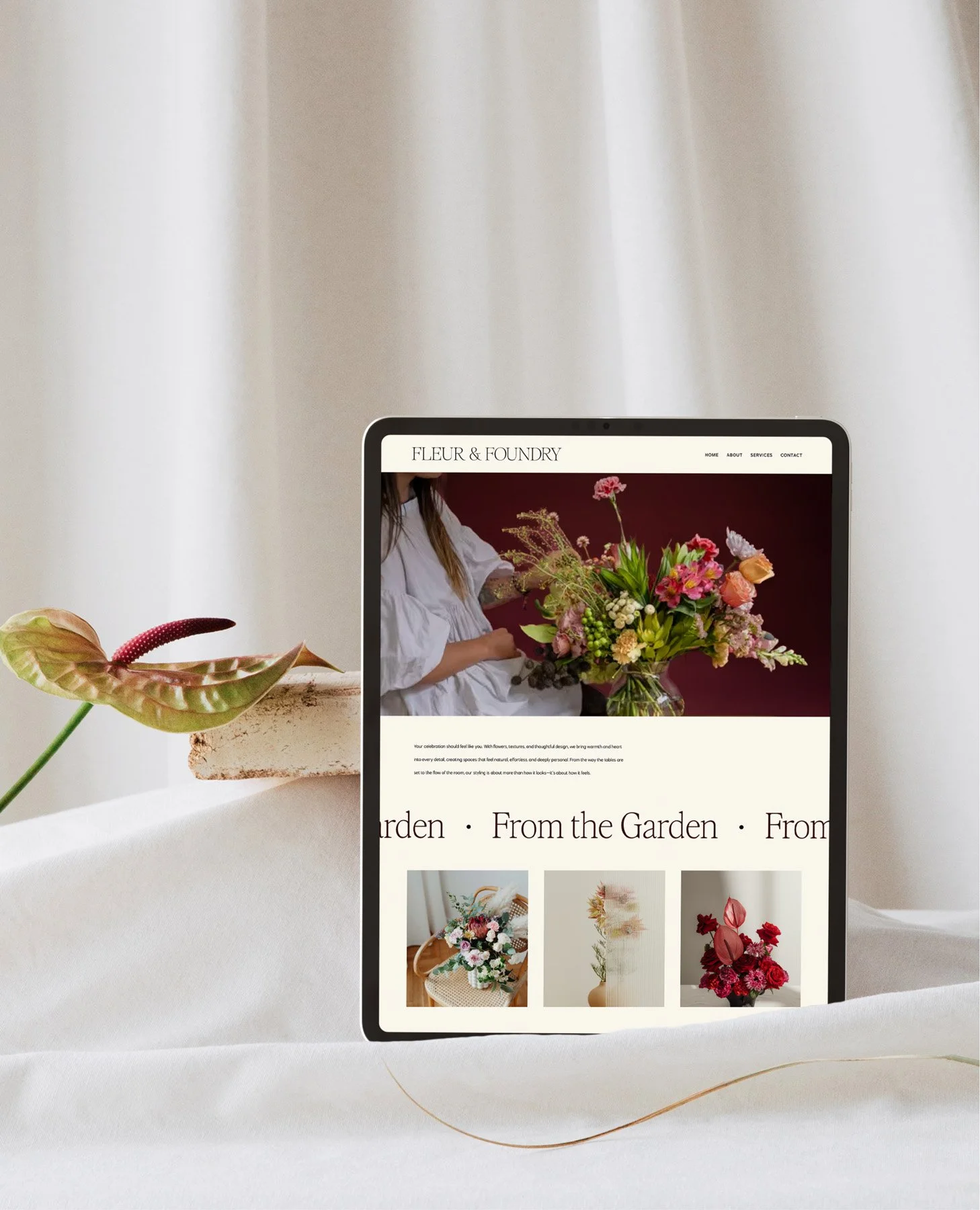 Tablet displaying the Fleur & Foundry website homepage with a floral hero photo and gallery.