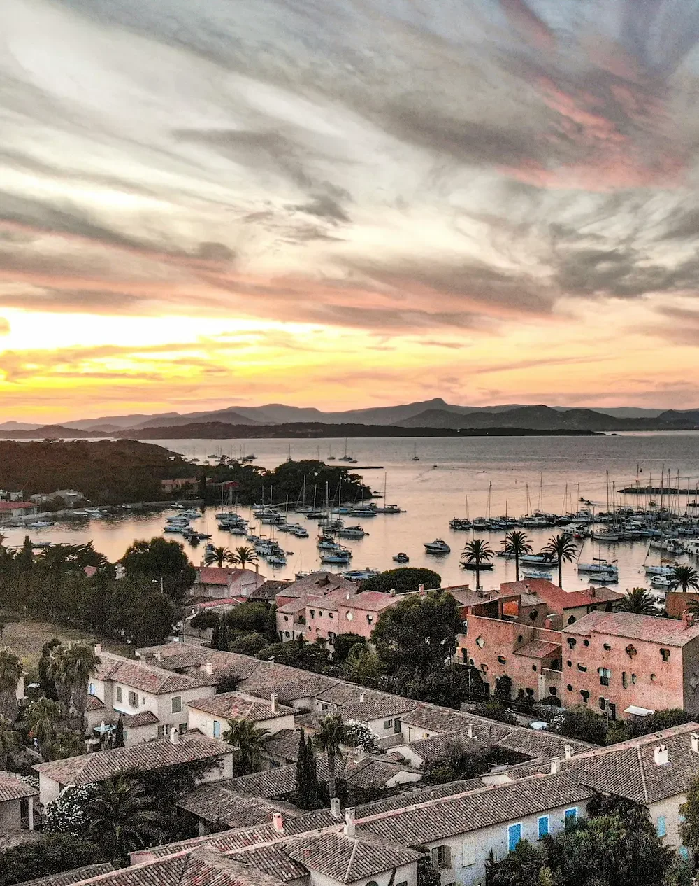 Aerial view of Saint-Tropez bay at sunset with yachts at anchor