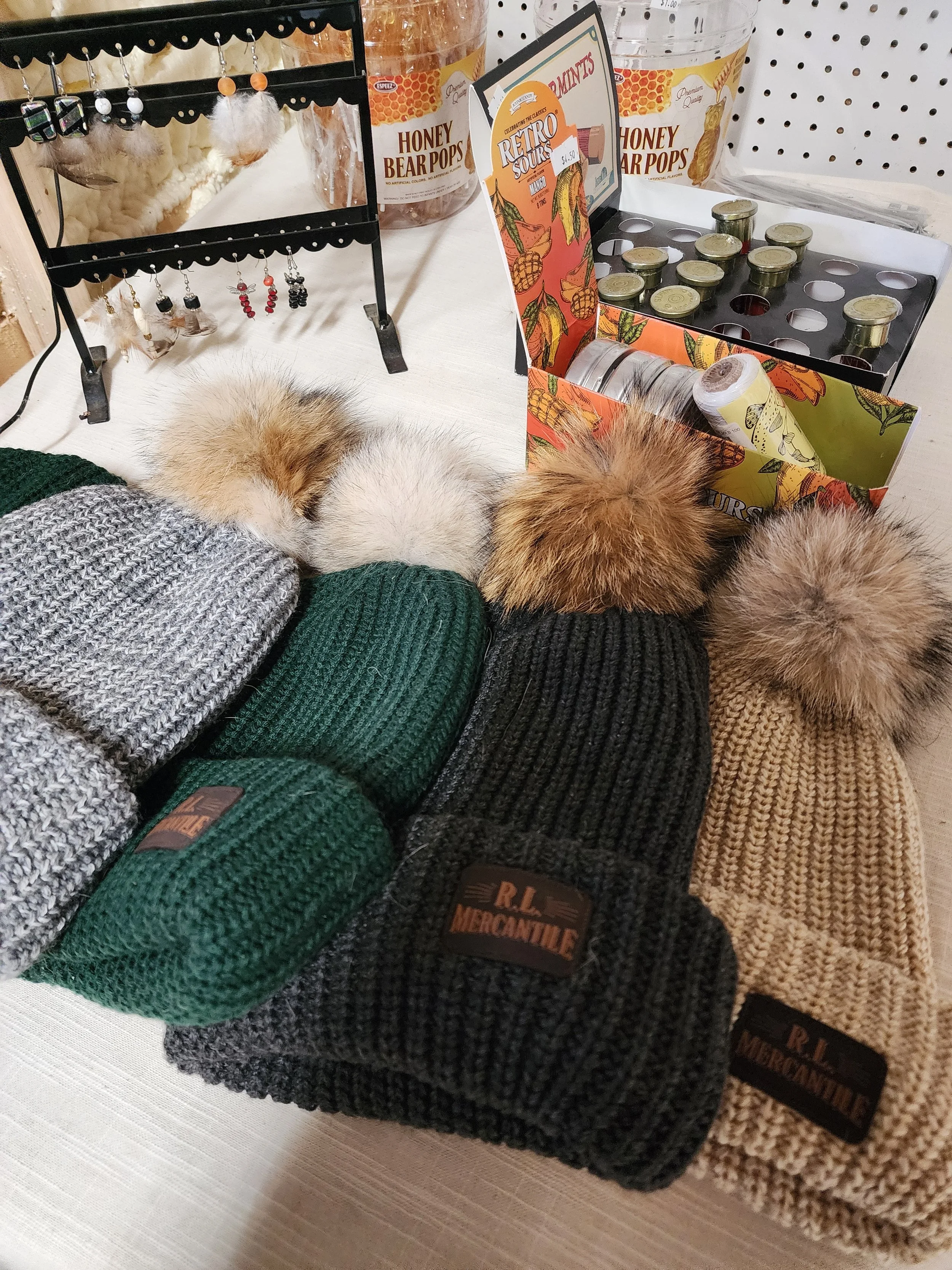 Winter beanies with coyote fur pom pom