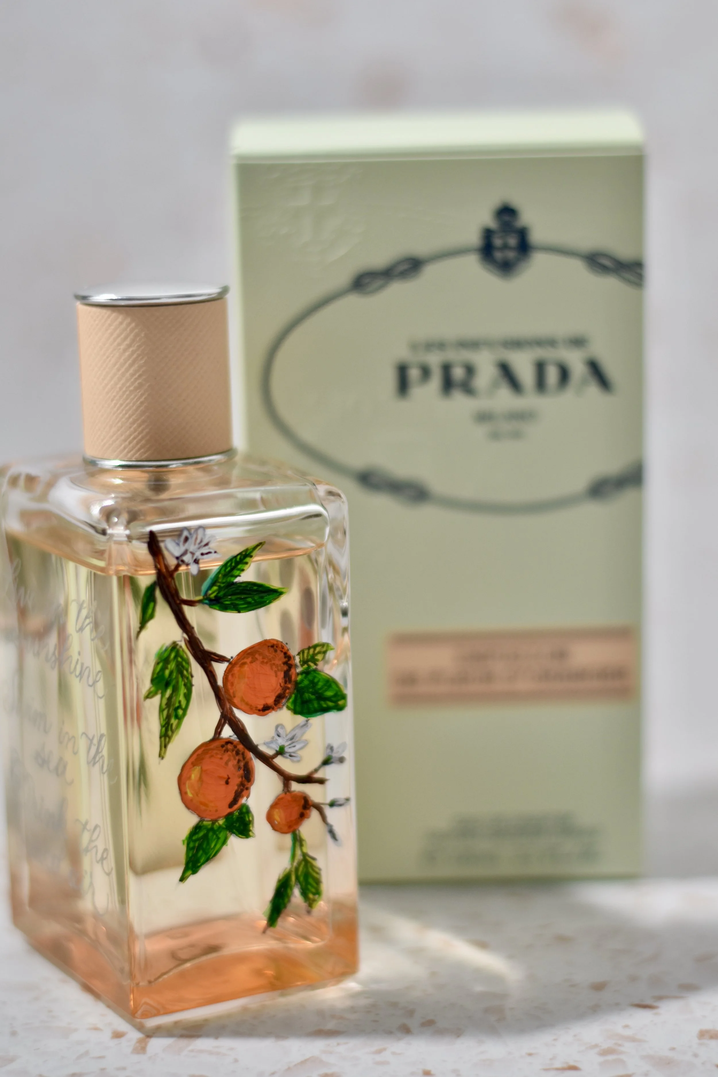 Hand painted oranges on Prada fragrance