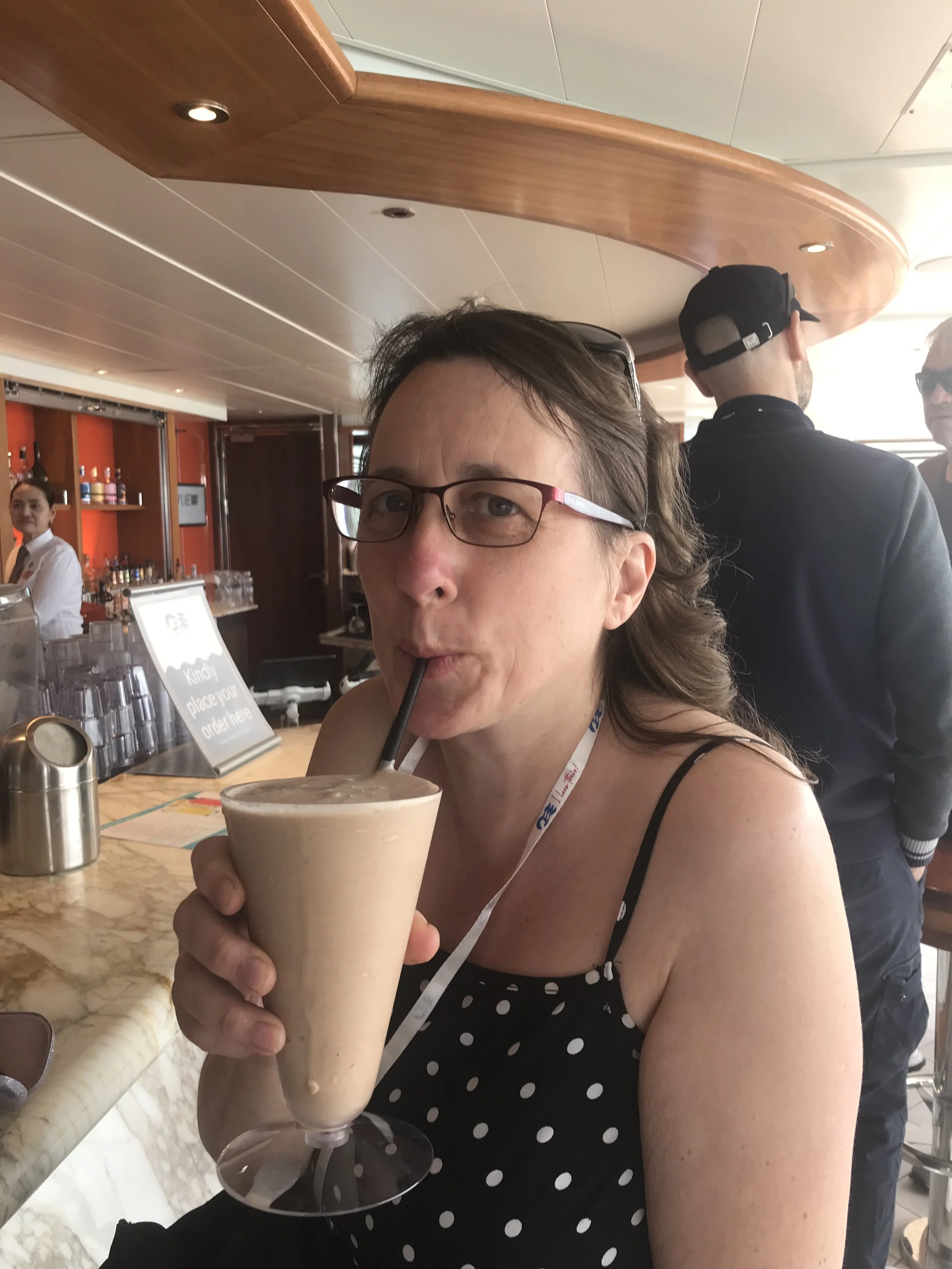 Lorraine McCowatt drinking a cocktail on a cruise ship