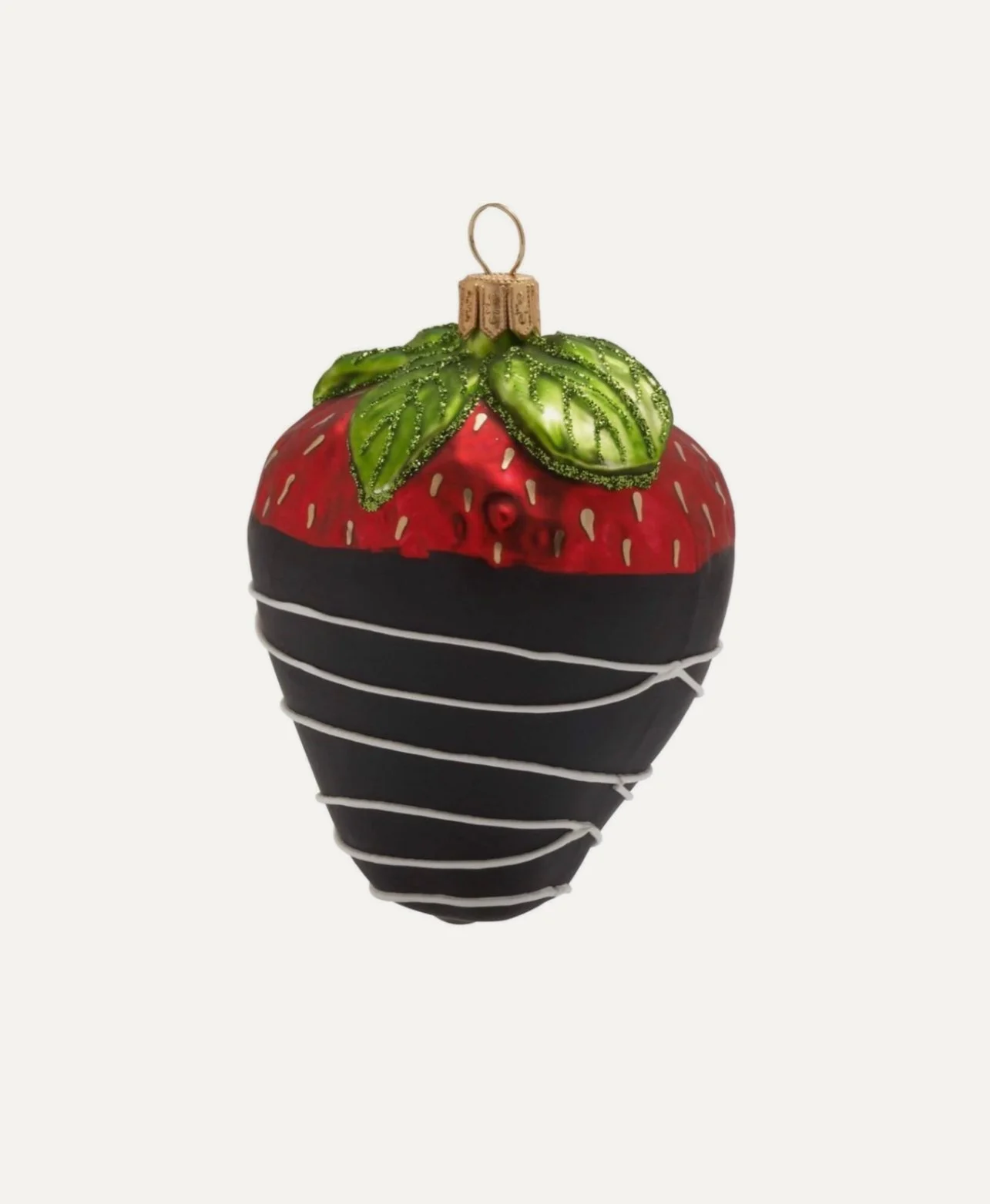 Decorative strawberry-shaped ornament with red, green, and black colors and white spiral accents.