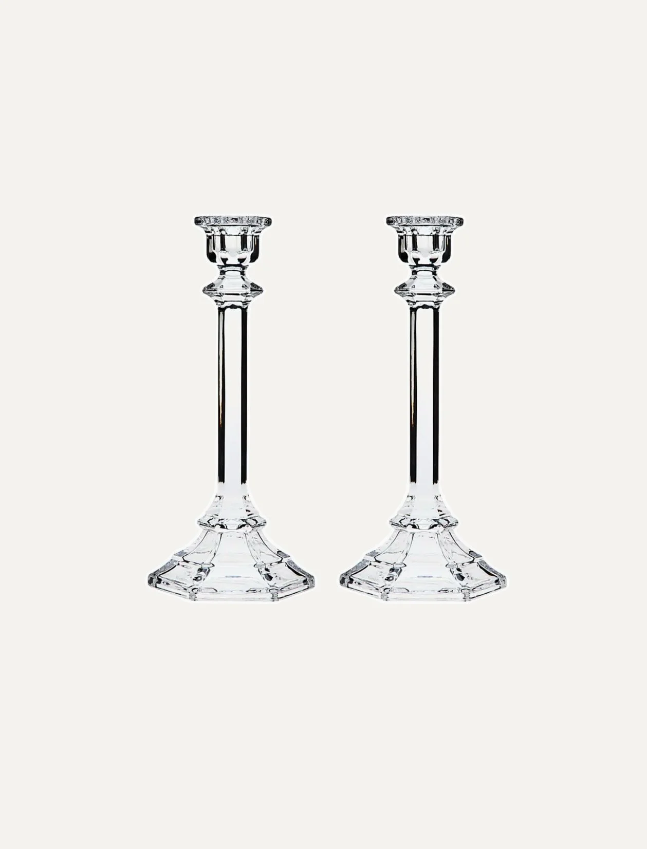 Two glass candlesticks with candle holders on a white background.