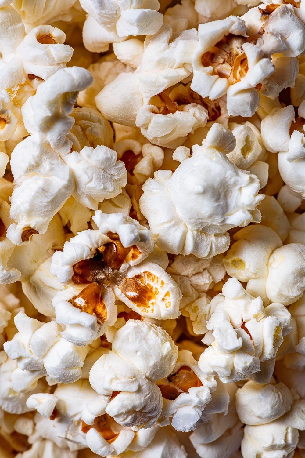 Close-up of freshly popped popcorn with some kernels still attached.