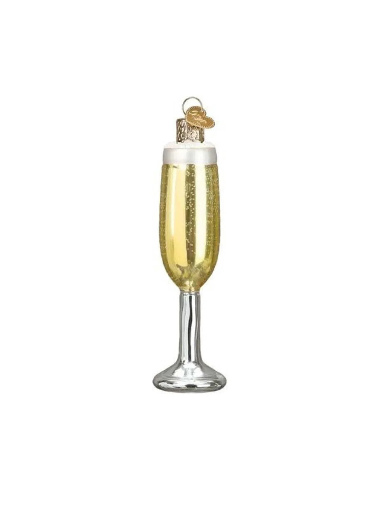 A champagne glass filled with gold champagne, topped with white foam, and decorated with a small gold shoe ornament.