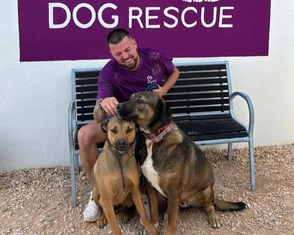 Lee Harker and two dogs, at the Paws Xaló shelter