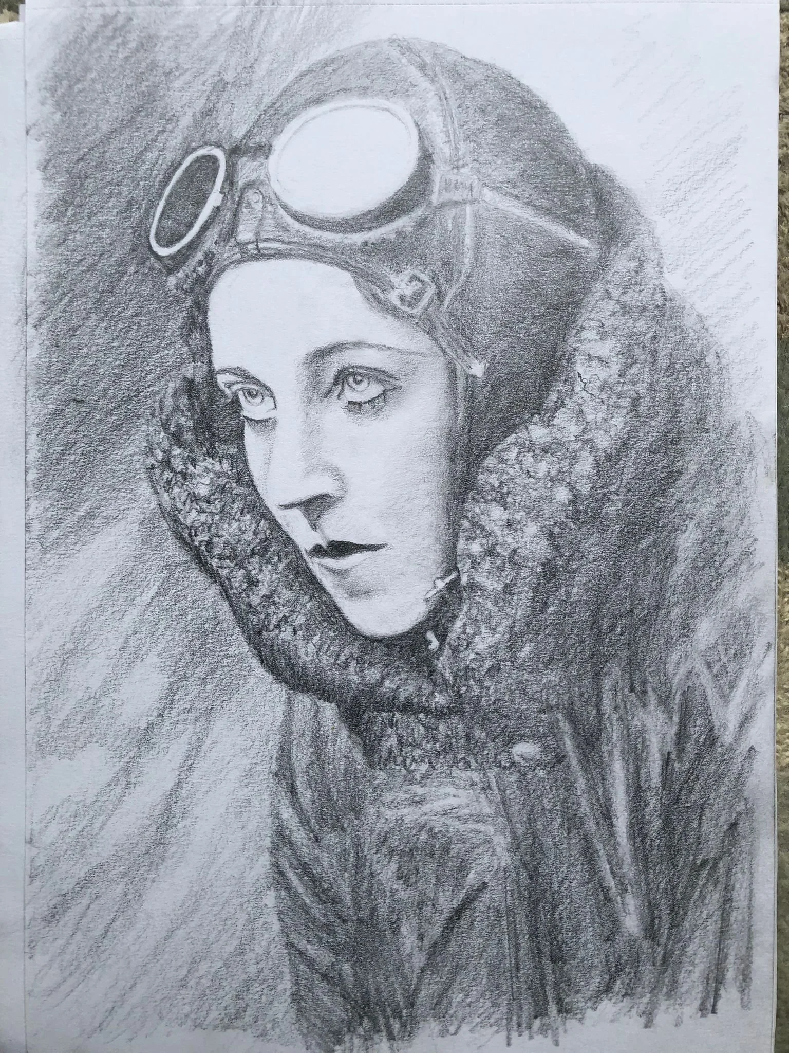 A detailed pencil sketch of a woman wearing goggles on her head and a fur-lined coat, with her head turned slightly to the side and a serious expression.