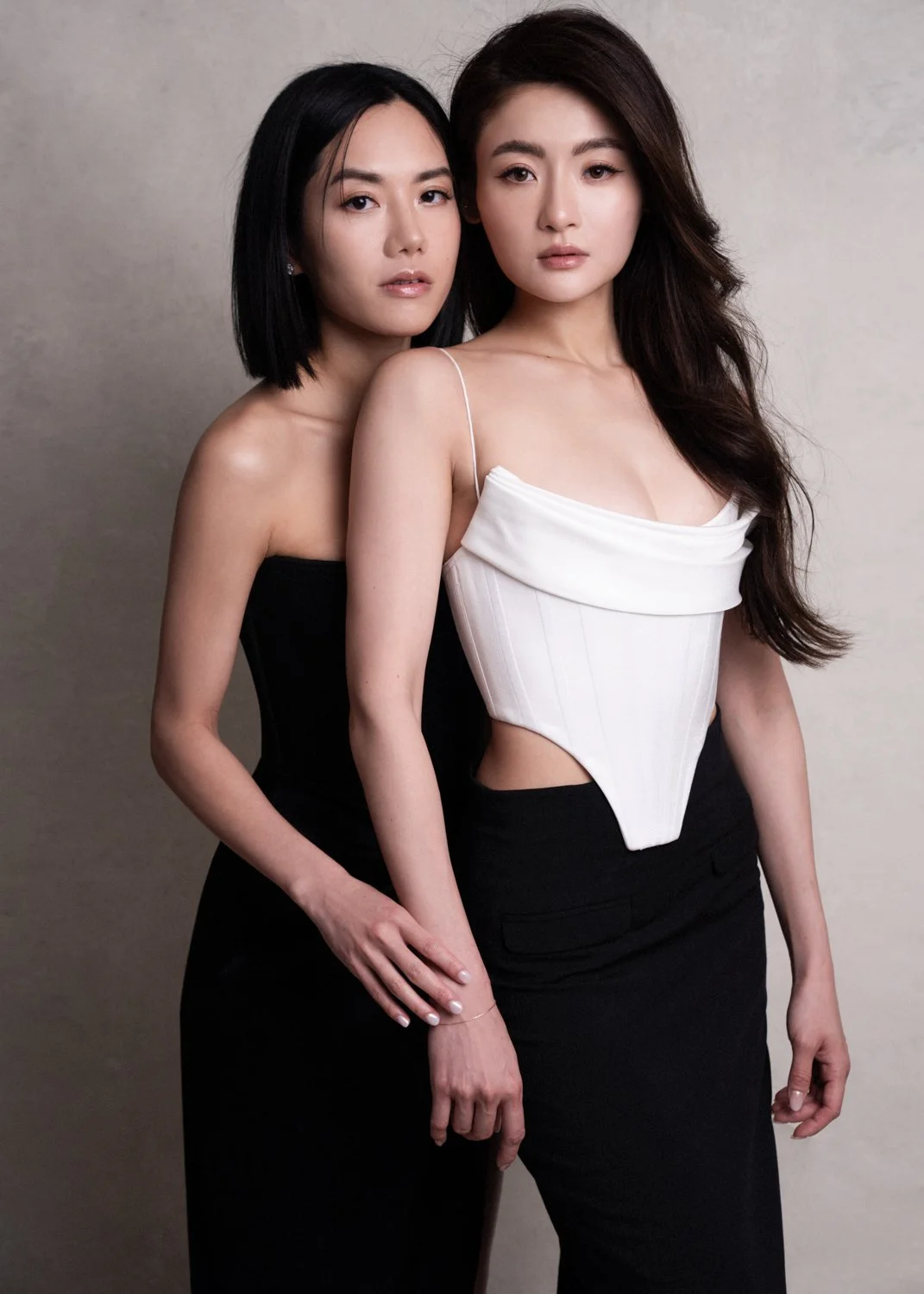 Editorial style portrait photographed by Kay Lai Studio in Hong Kong. Two girls pose together as friends, capturing a fashionable and timeless connection.