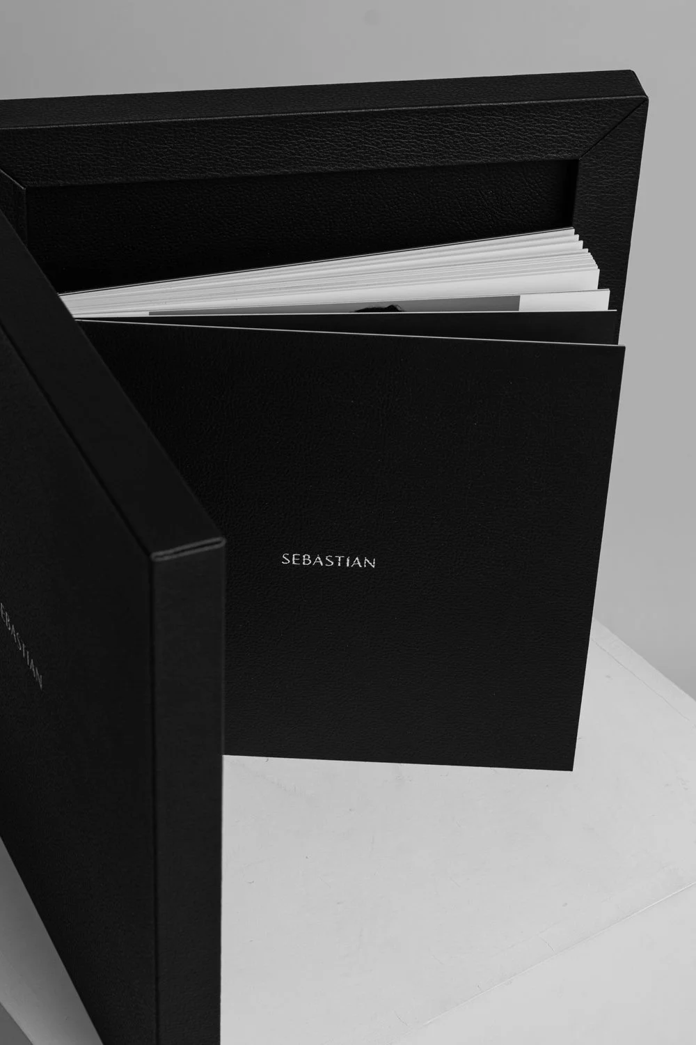 Black box with the word 'SEBASTIAN' on it, with papers or documents inside.