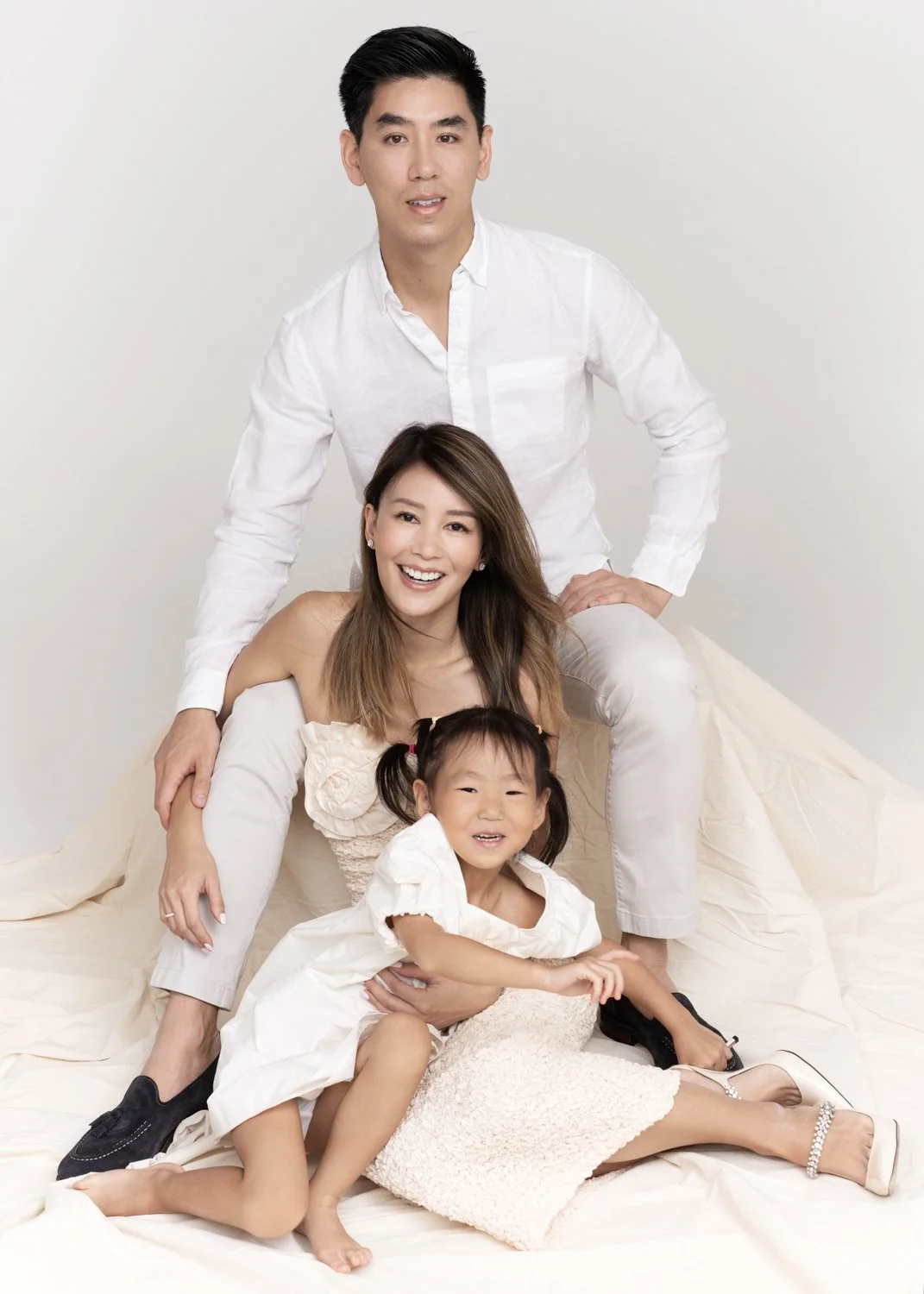 Fashion editorial family portrait photographed by Kay Lai Studio in Hong Kong. Mother, father and daughter styled elegantly together, capturing a timeless and fashionable family moment.