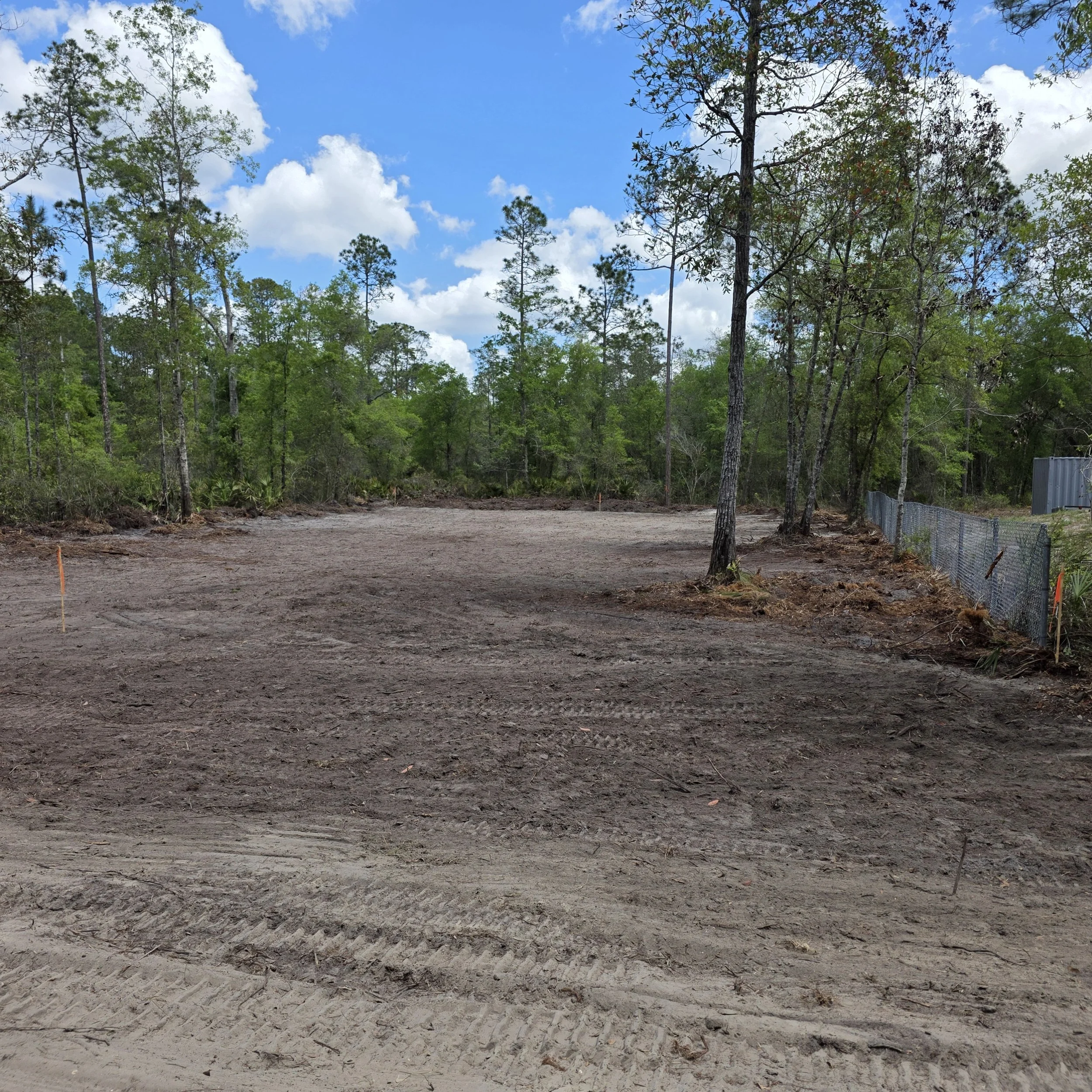 Cleared and smoothed quarter-acre homesite after root raking in Interlachen, Florida