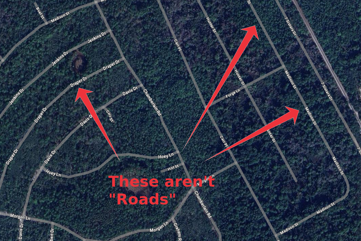Satellite map showing several streets with three red arrows pointing to different streets. The text in red says 'These aren't