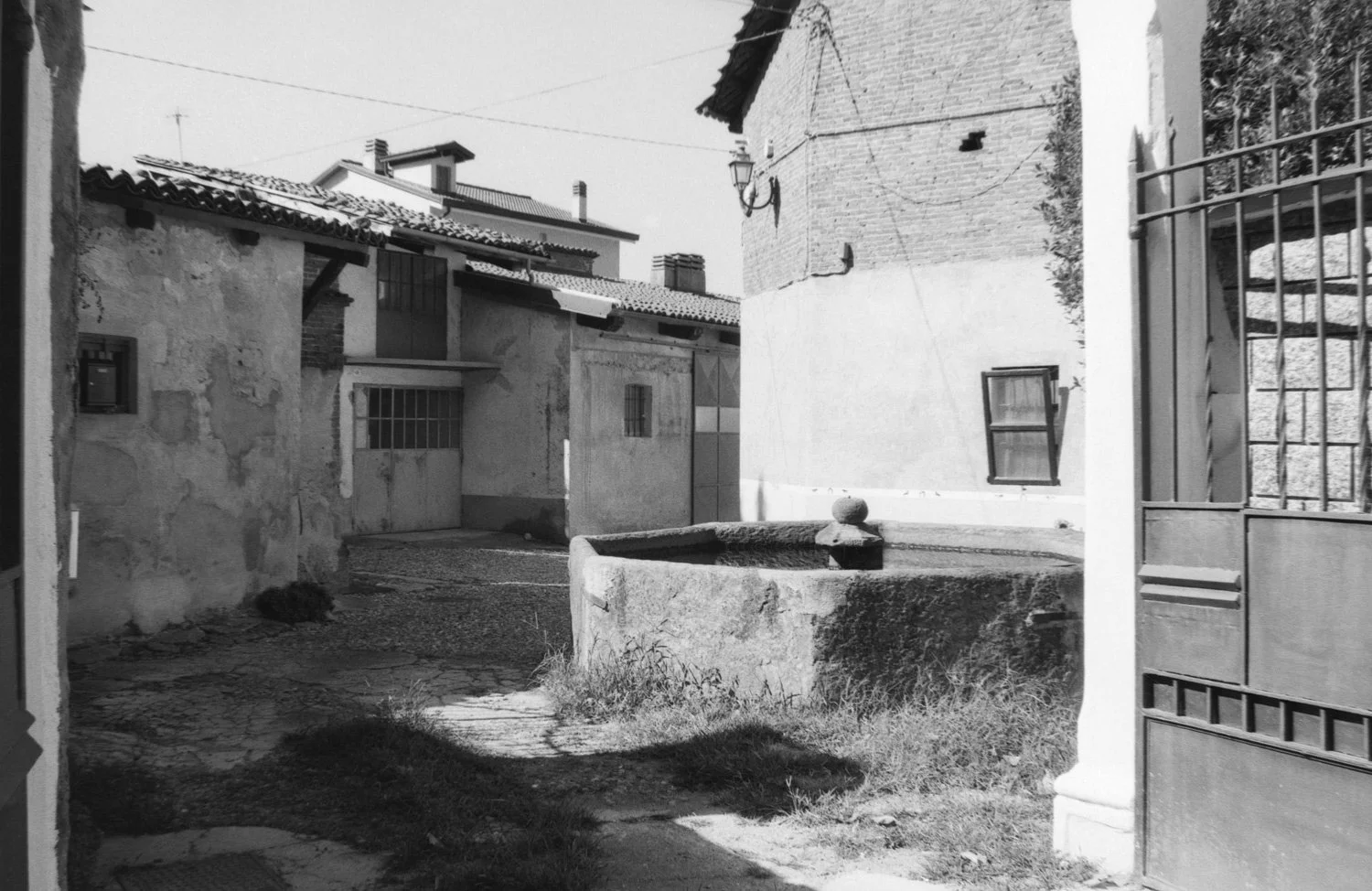 bright black and white octagonal stone fountain frame by gate
