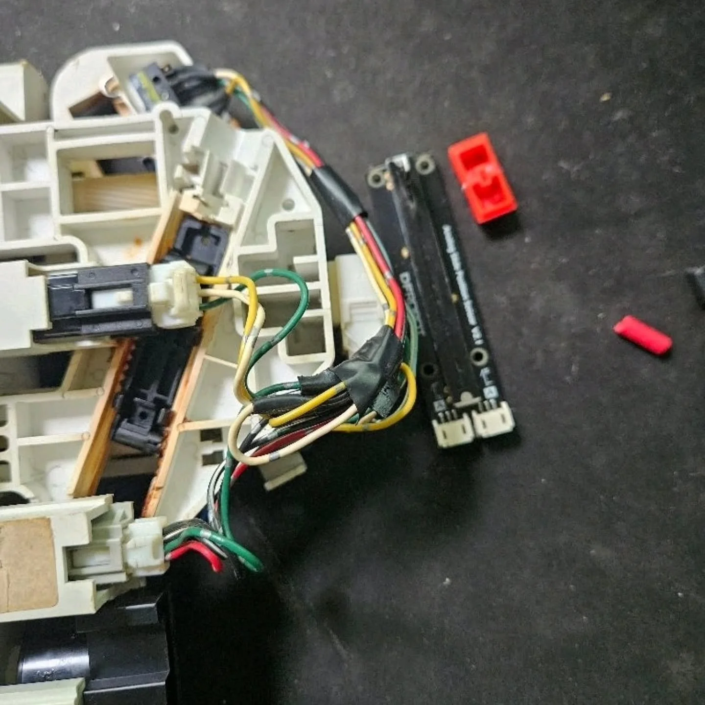 Getting controls assembled for the heater. We've removed the whole control assembly and have attached a sliding potentiometer from @dfrobot_official. We're using some insulation trimmings glued to the sliding cable actuator to connect the pot.
Physi