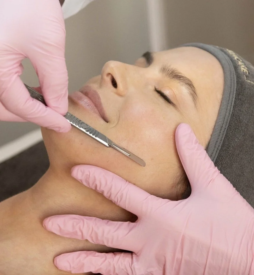Dermaplaning facial process using a medical-grade blade for gentle exfoliation