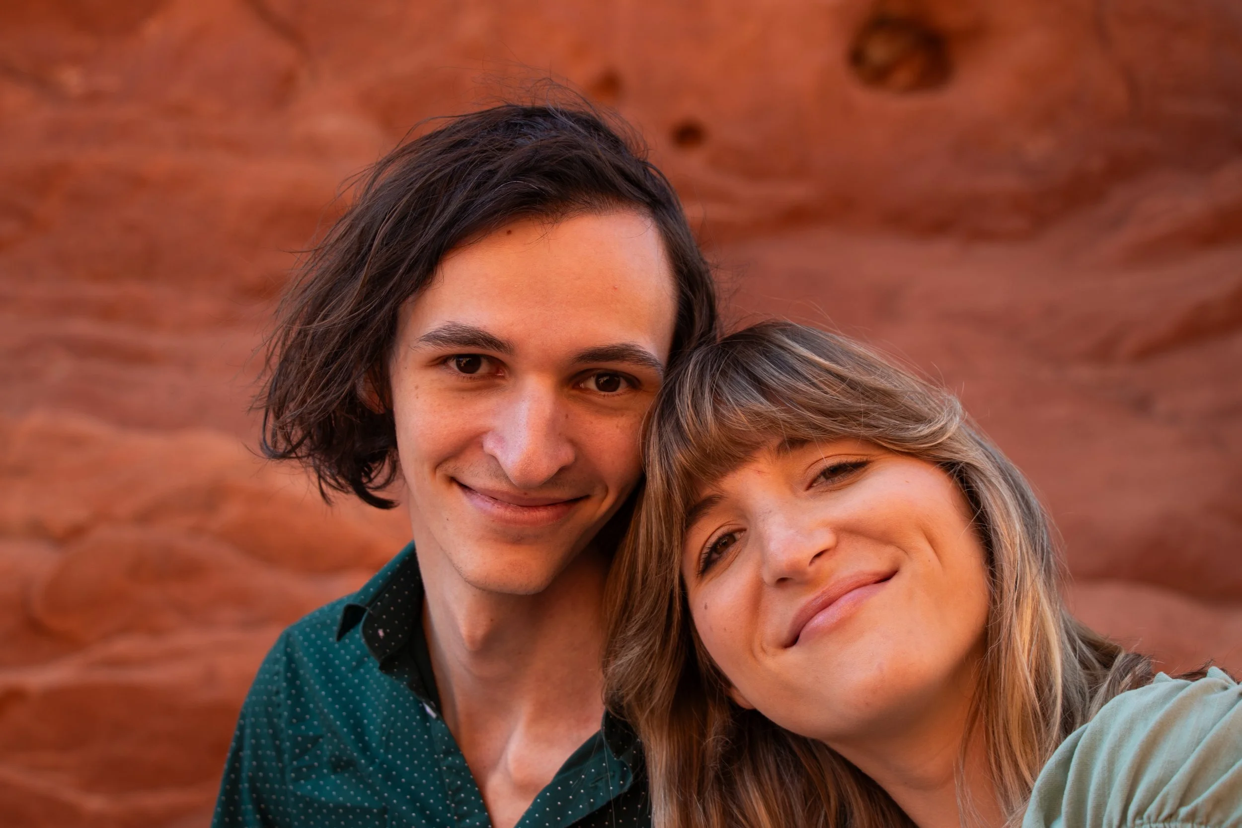 A young couple outdoors celebrating their engagement.
