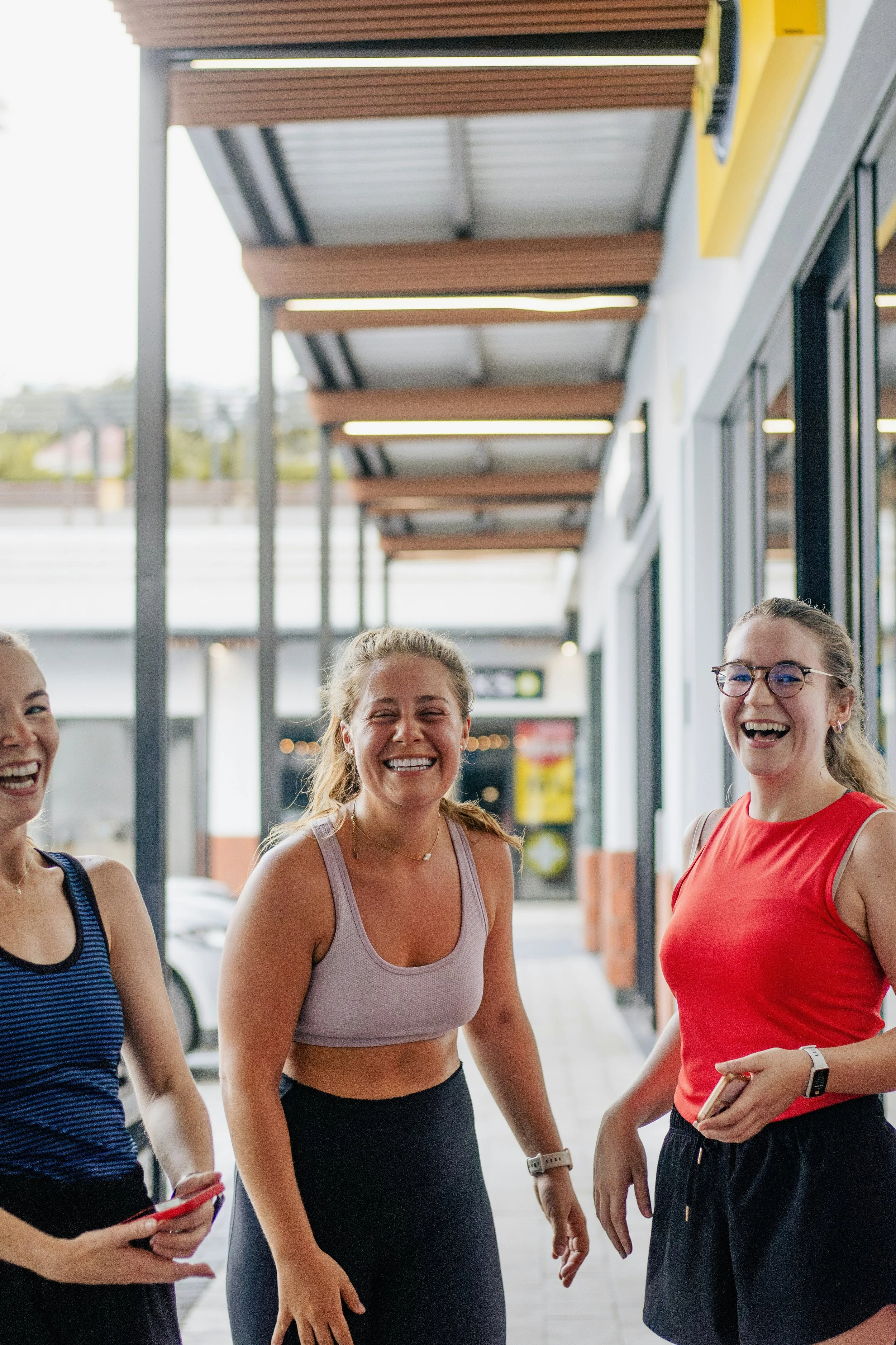 Group of women laughing together after a fitness and wellness session at Hiller Wellness