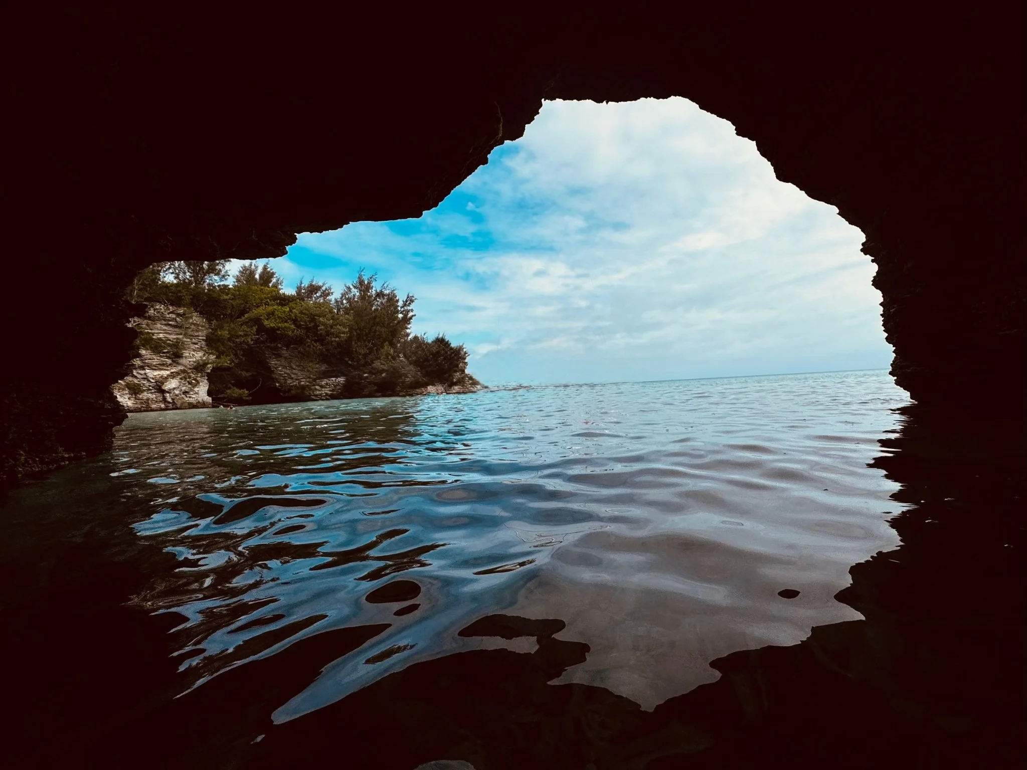 View from inside a cave looking out toward open water and sky — symbolizing reflection, clarity, and perspective along the journey.