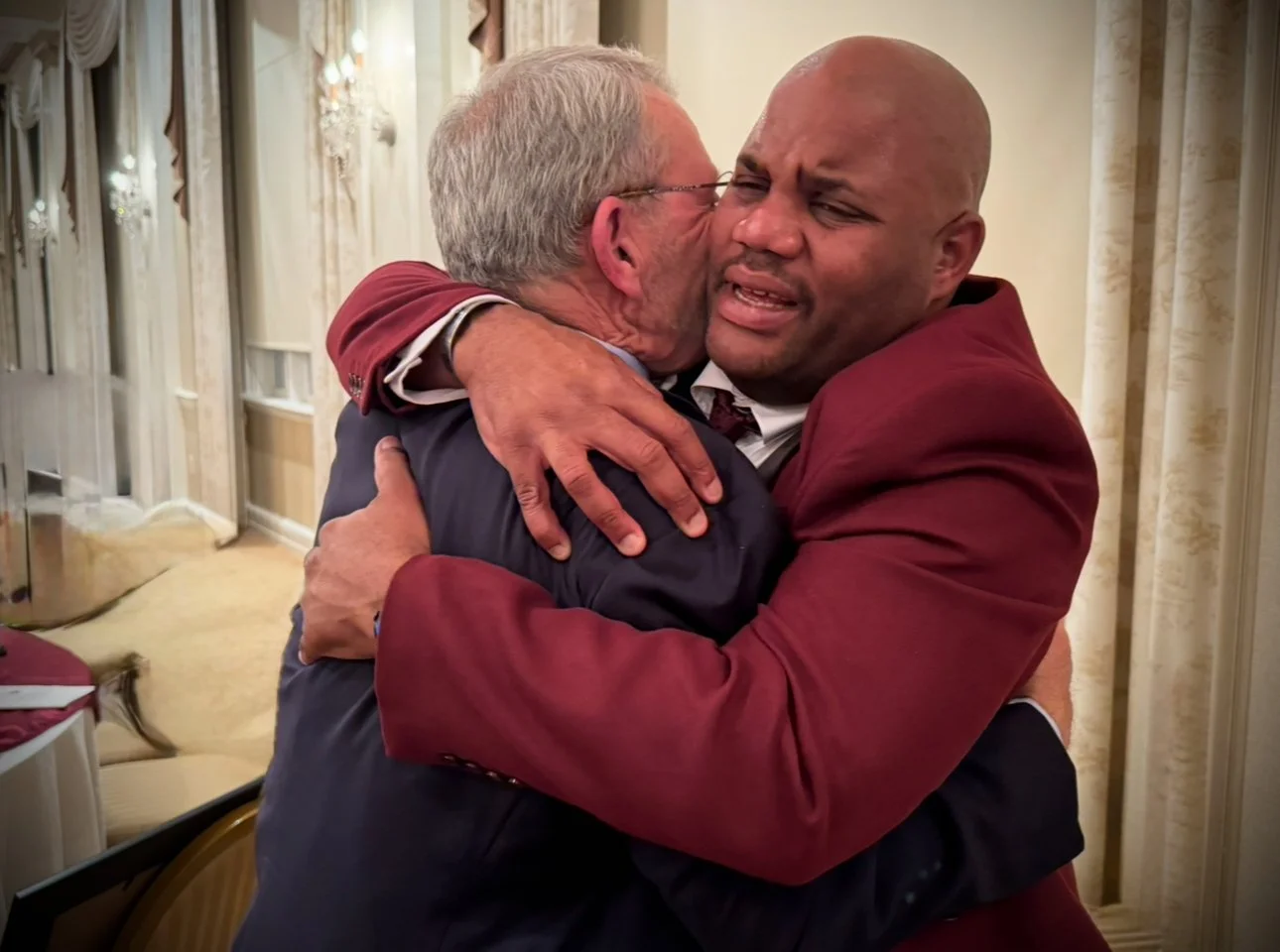 Two people share an emotional embrace — a moment of genuine care and connection captured in time, reminding us that leadership begins with humanity.