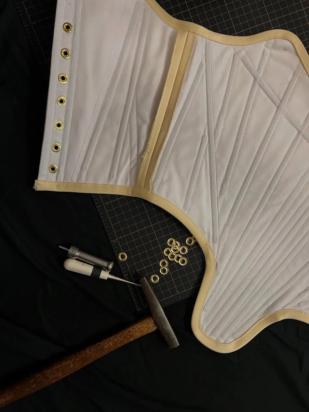 Detail shot of grommets on a custom corset