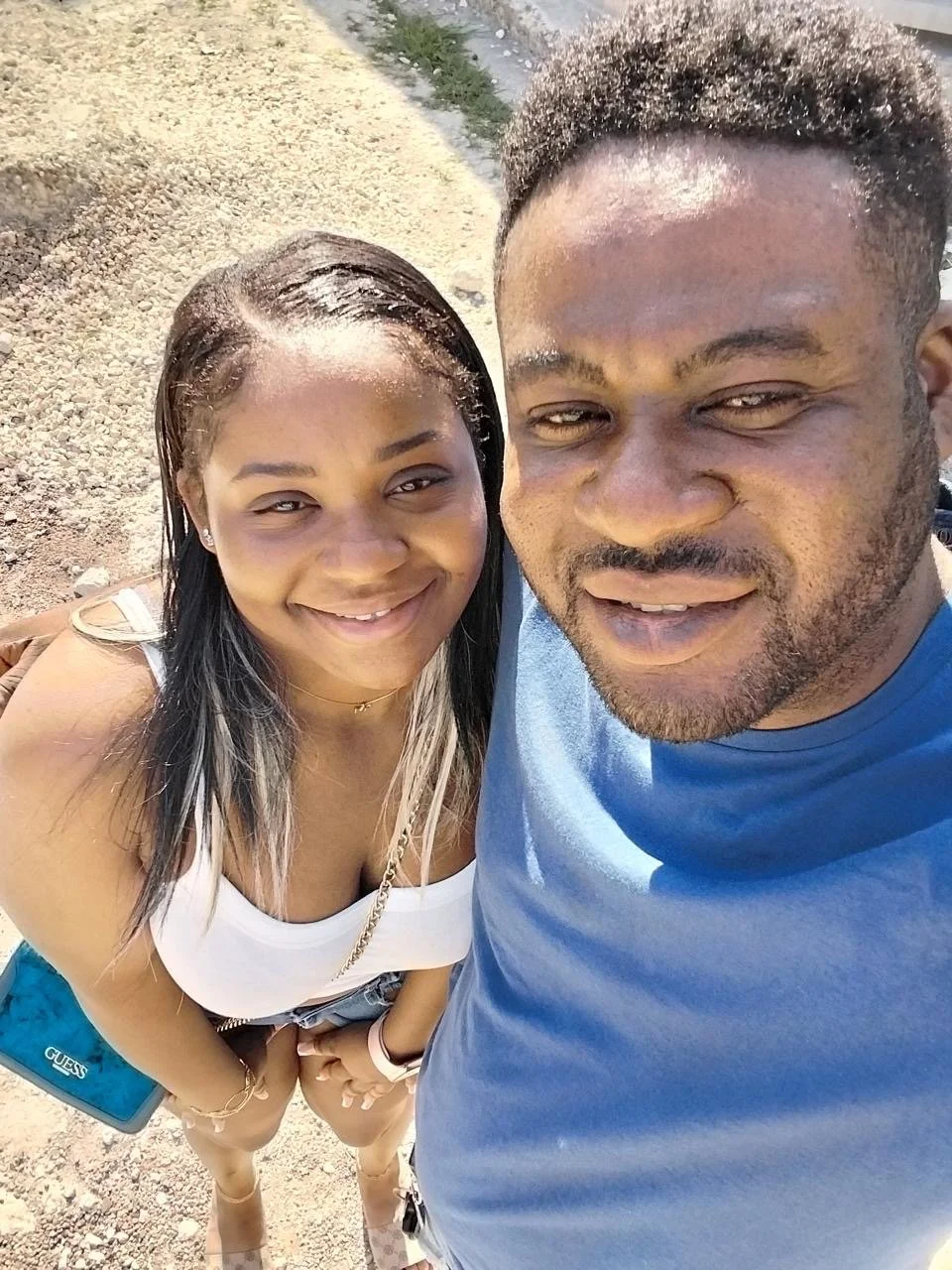 Picture of a Jamaican man and woman in front of a van