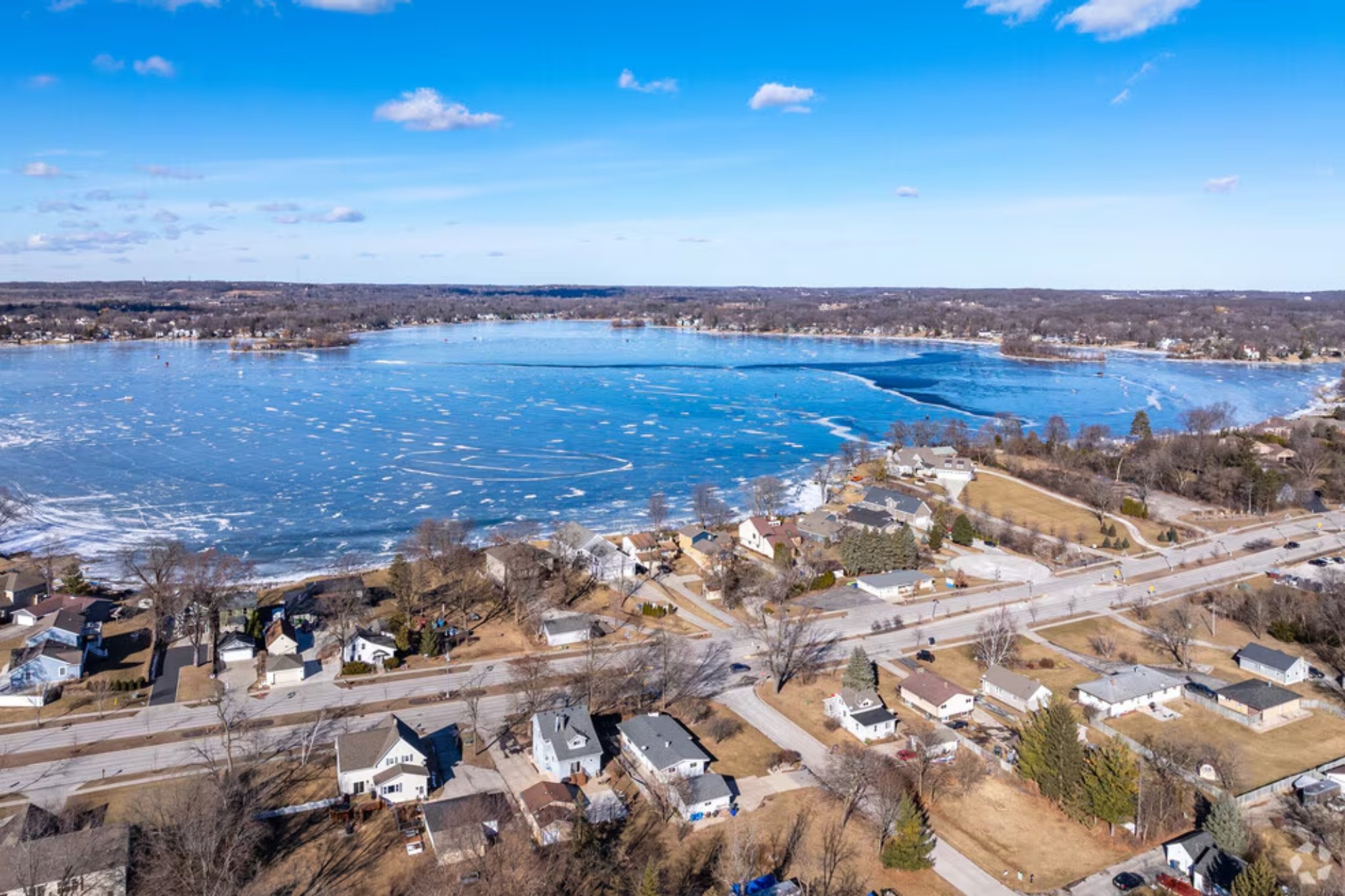Aerial view of Lake Muskego and surrounding neighborhood roofs in Muskego, Wisconsin