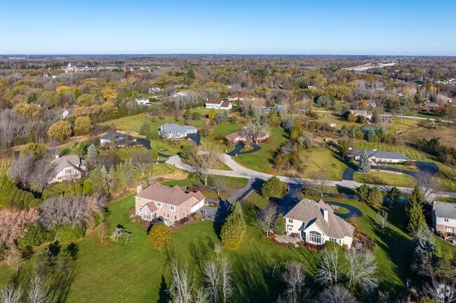 Aerial view of residential homes and neighborhood roofs in River Hills, Wisconsin