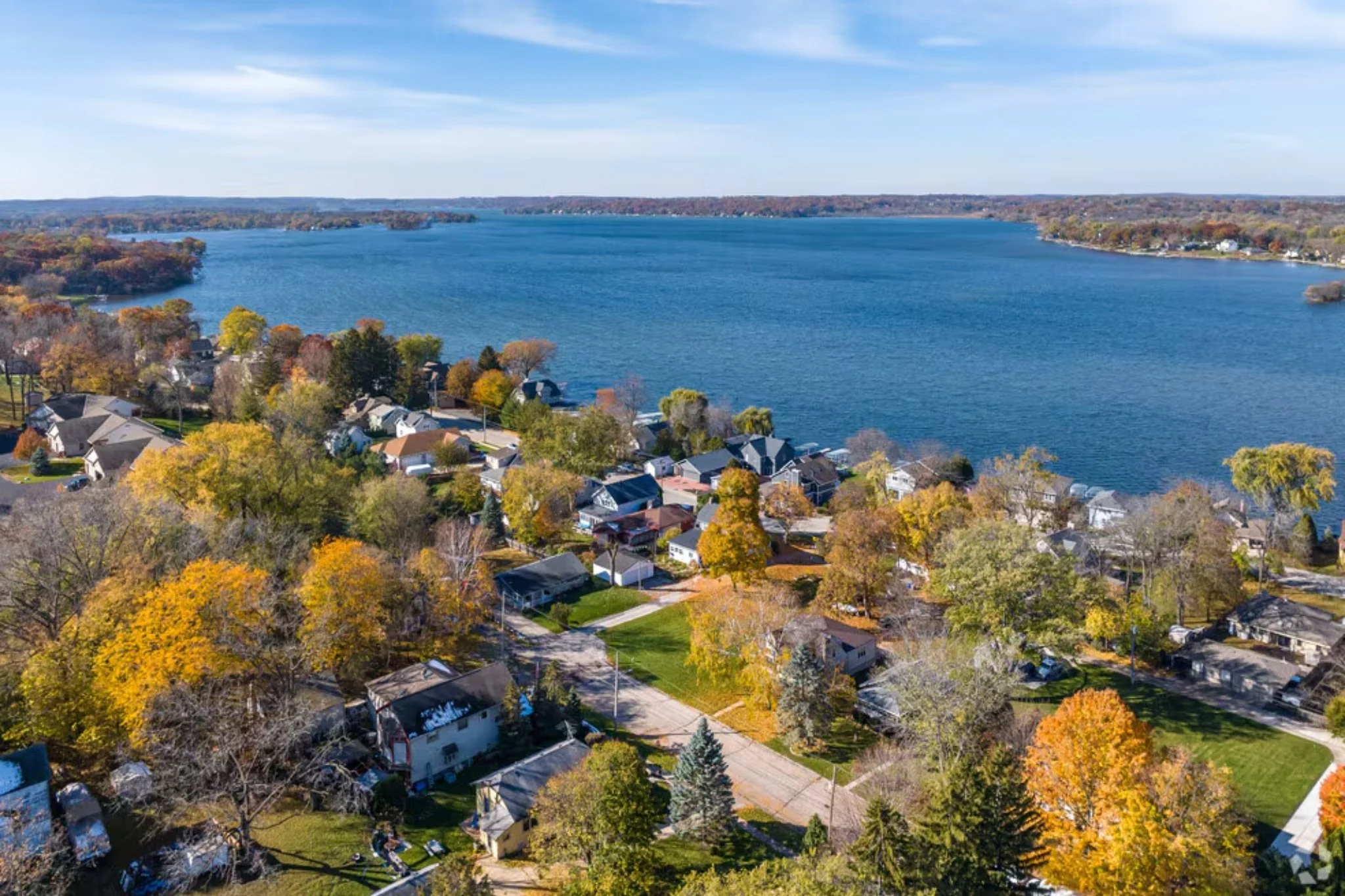 Aerial view of residential neighborhoods and roofs and lakes near Hartland, Wisconsin