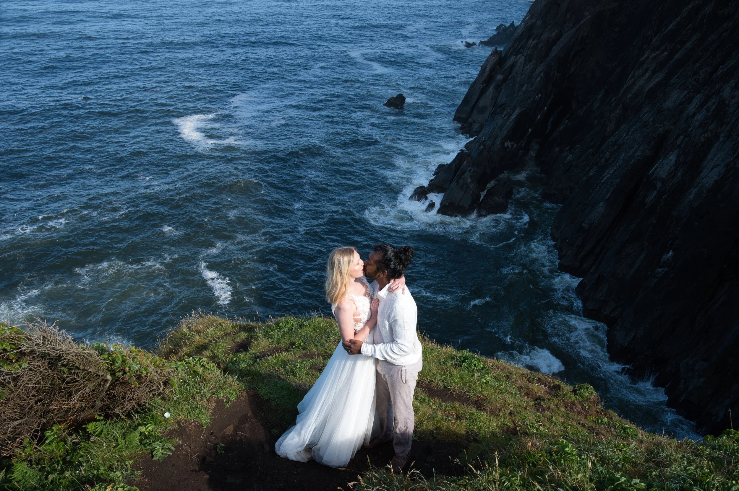 Couple standing on the cliffs at Neahkahnie Cliffs along the Oregon Coast during their elopement