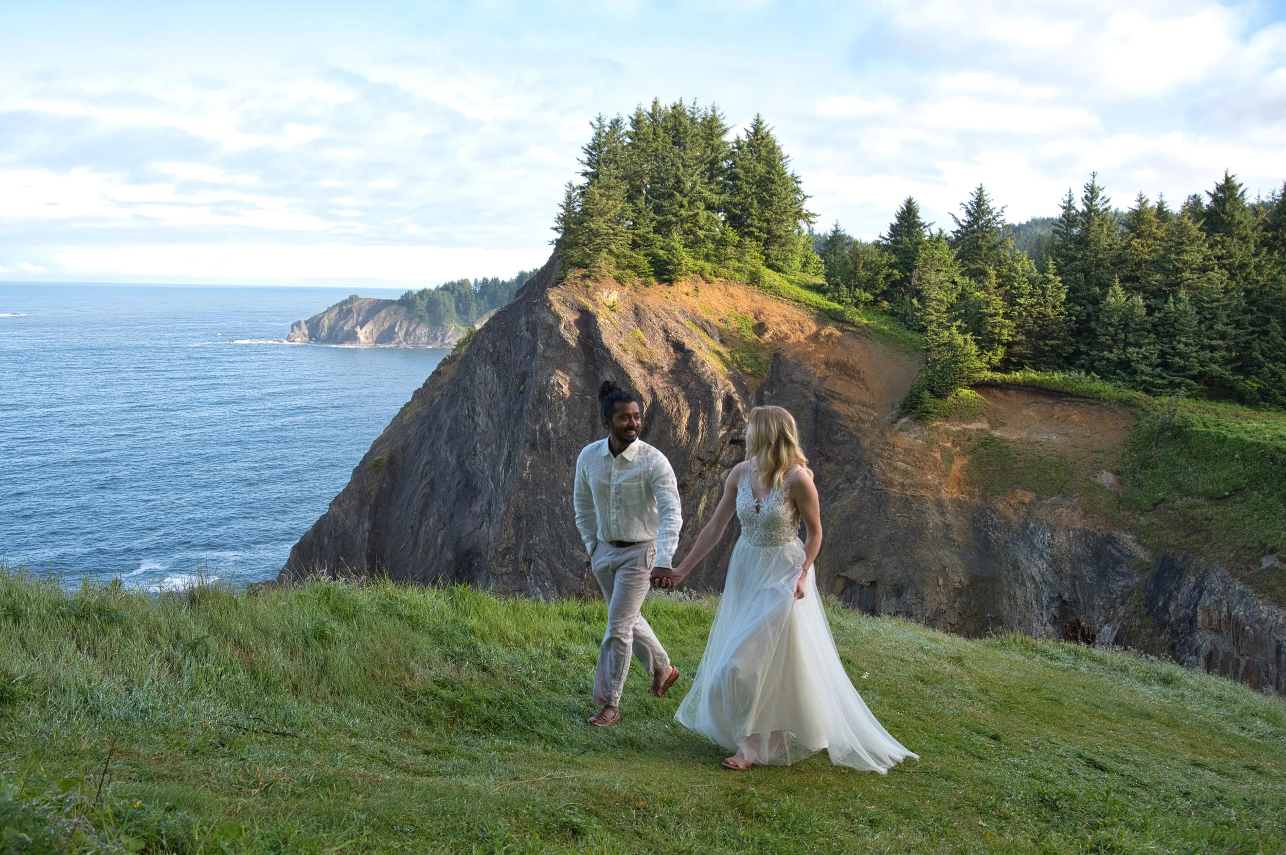 Oregon Coast elopement at Ecola State Park with couple running along cliffs