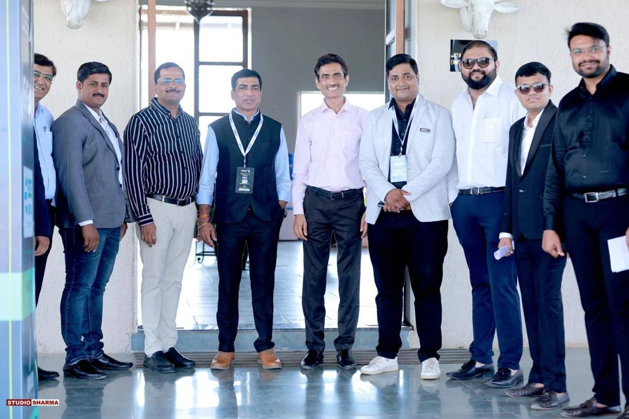 Group of eleven men standing together indoors, smiling for the camera at an event or conference.Youth Con by CREDAI Amravati - At chikhaldara. - With President - Rajen Patil 