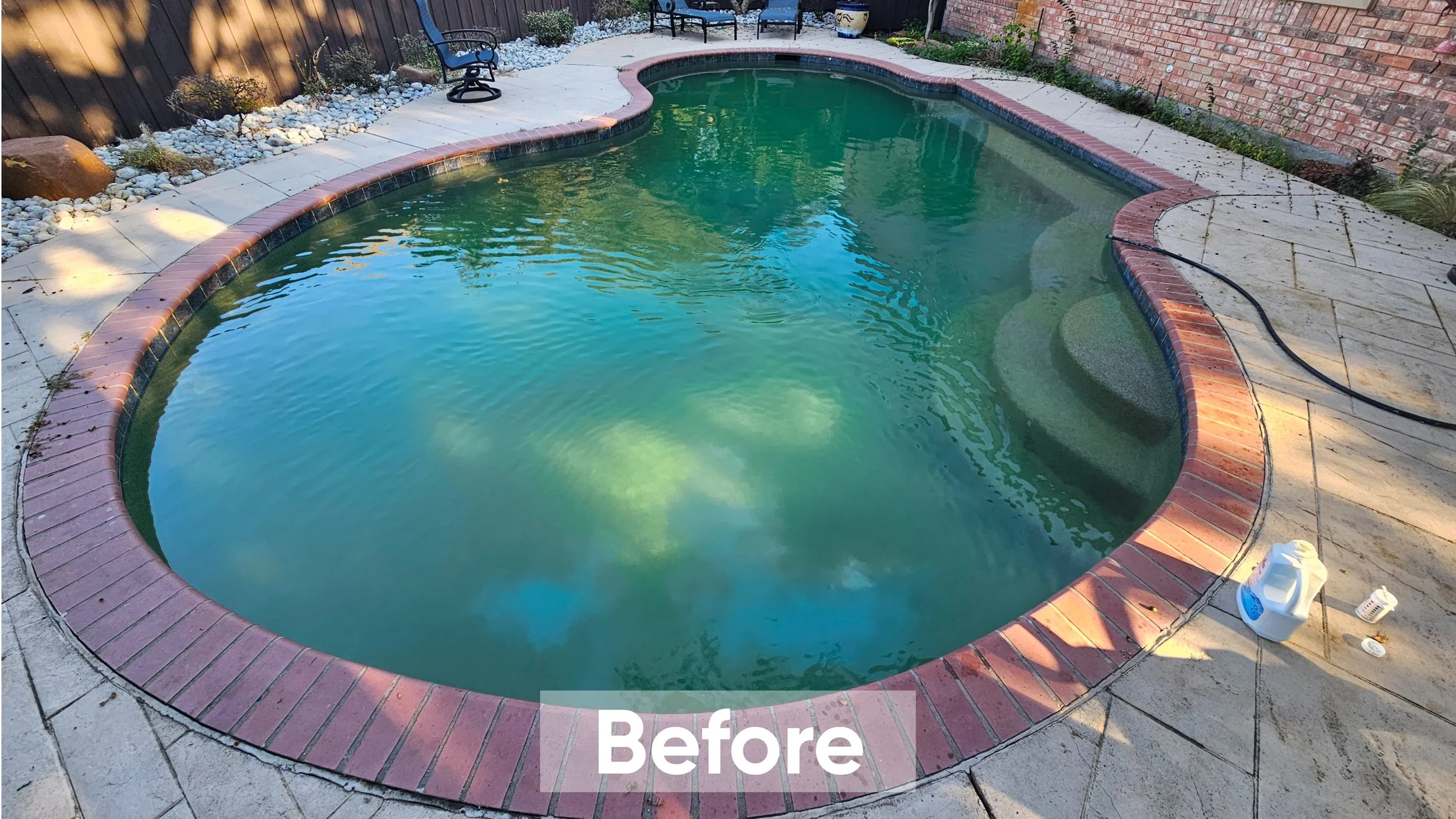 An above ground swimming pool with green water, surrounded by a concrete deck, brick border, and a backyard with a brick wall, plants, and outdoor furniture. There are cleaning tools and a jug on the deck. The word "Before" is written at the bottom.