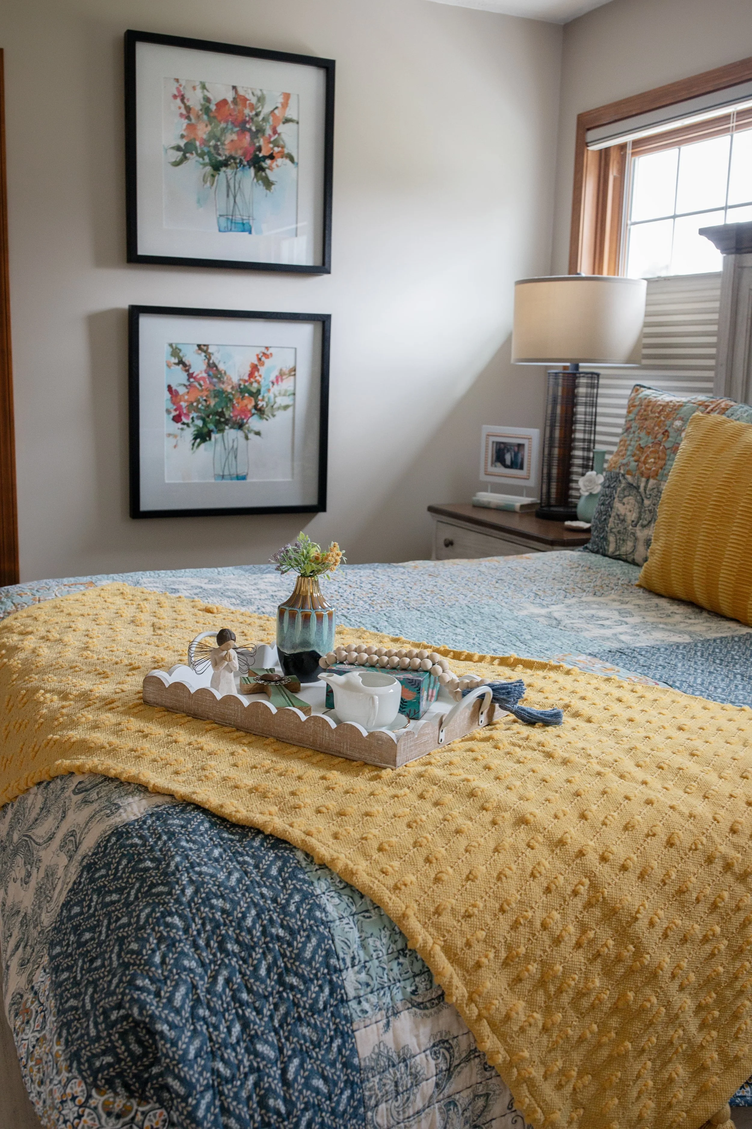 Cozy bedroom interior design with layered textiles, soft color accents, and curated décor, creating a warm, welcoming retreat in Southwest Michigan.