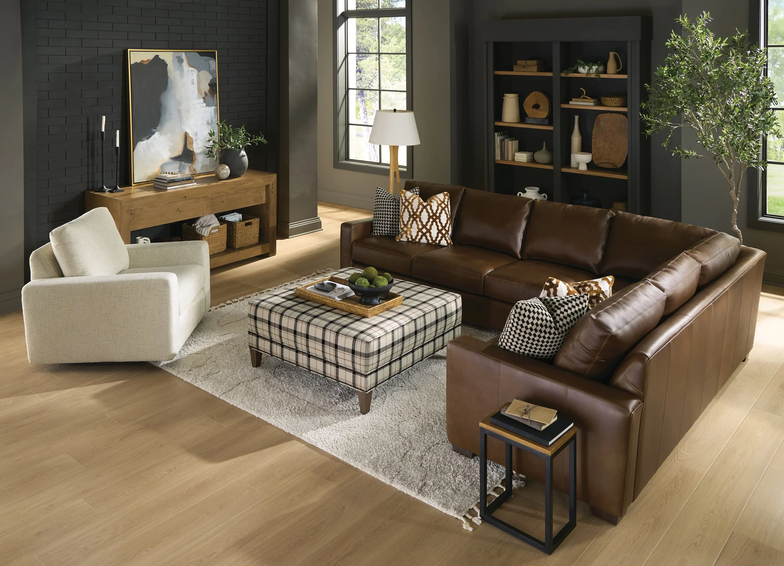 Top-down view of five colorful sofas arranged in a living room with hardwood flooring, each with decorative throw pillows in various patterns and colors.