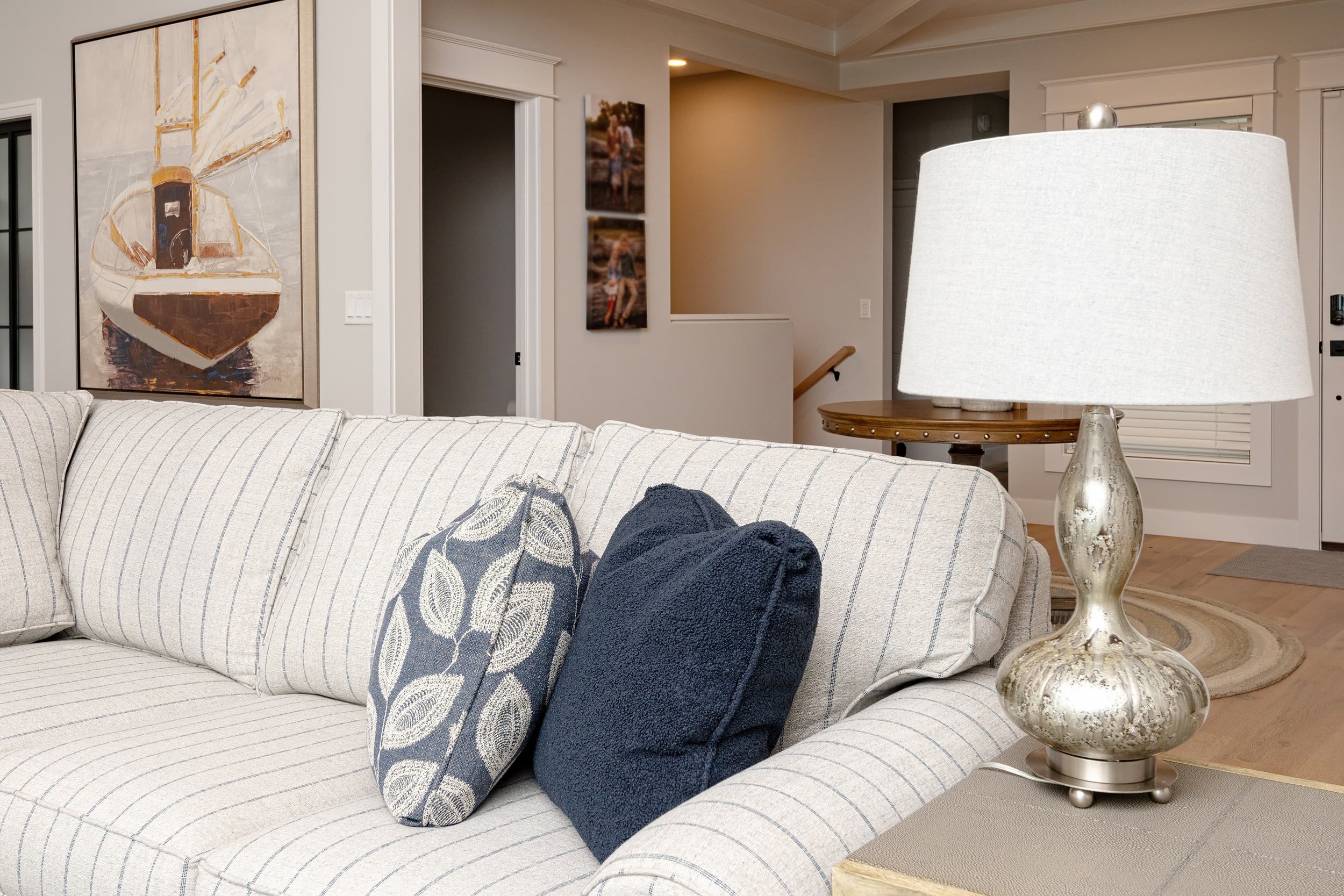 Living room interior design with custom upholstered sofa, layered accent pillows, and soft lighting, creating a comfortable, inviting space for everyday living in a Southwest Michigan home.