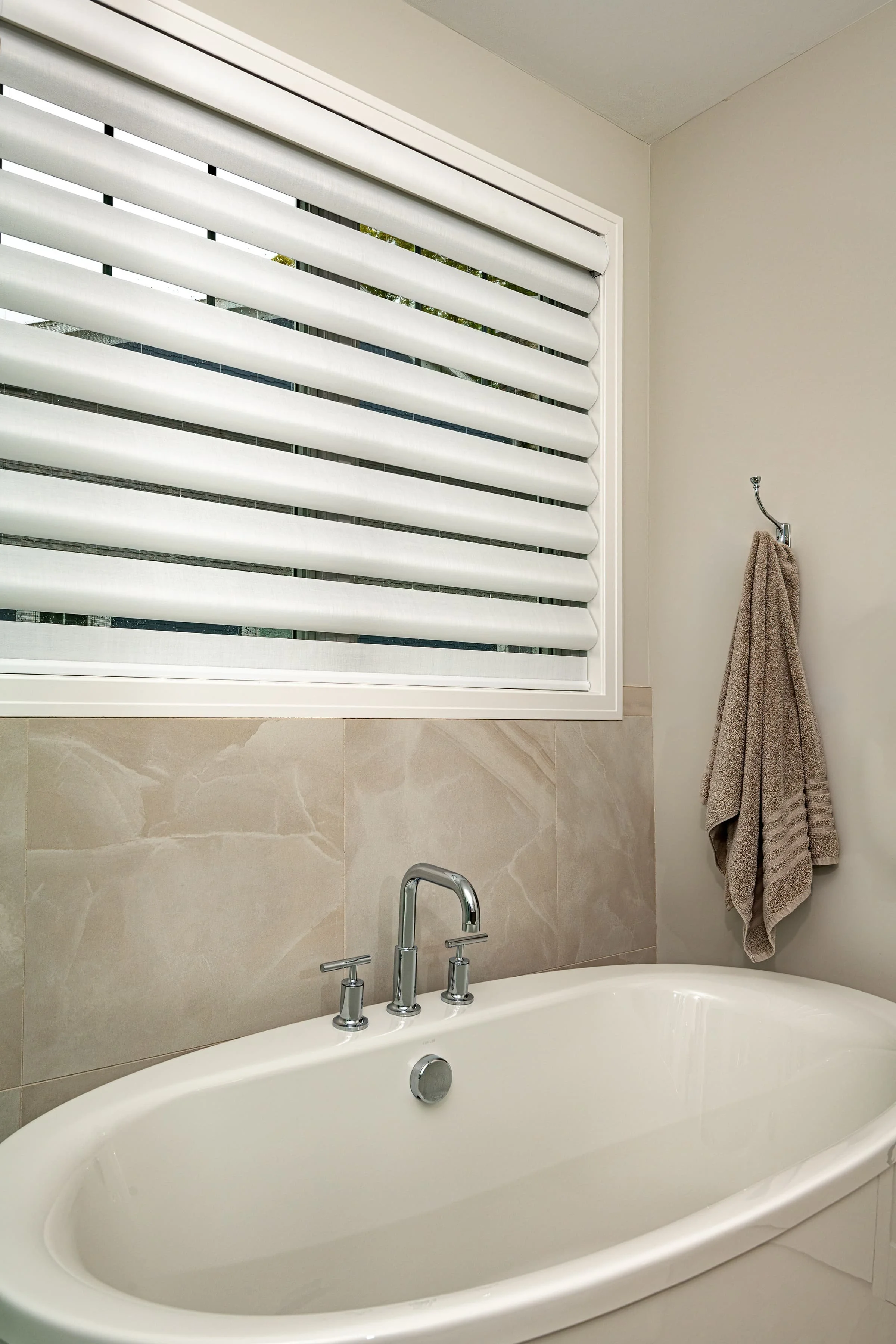Living room interior design with custom upholstered sofa, layered accent pillows, and soft lighting, creating a comfortable, inviting space for everyday living in a Southwest Michigan home.