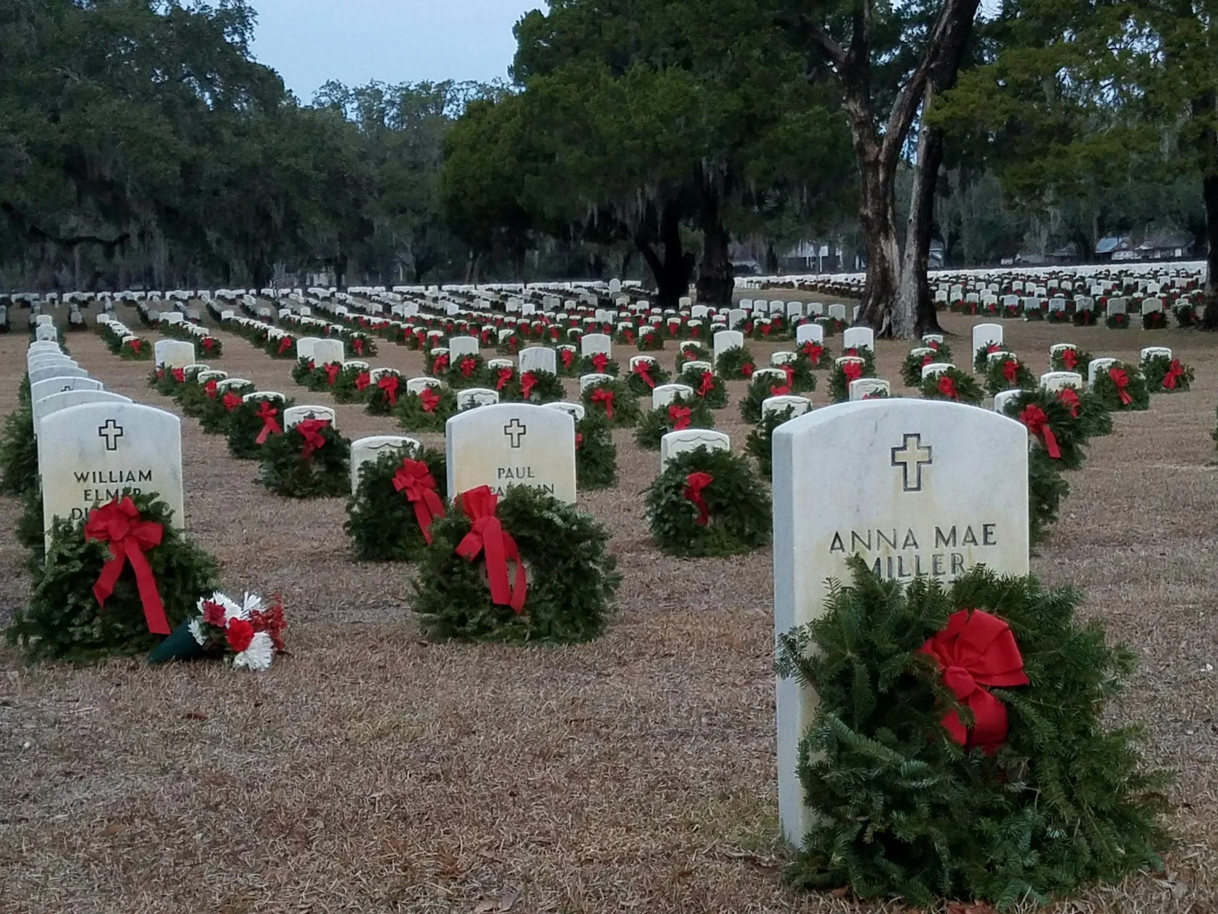 Graves in a cemetery adorned with wreaths
