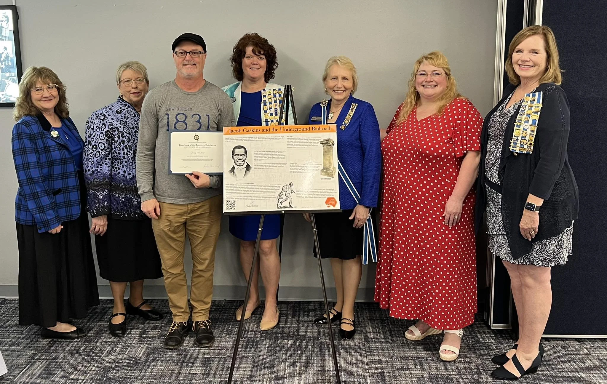 Members with a representative of the North Canton Historical Society and artifacts about Jacob Gaskins