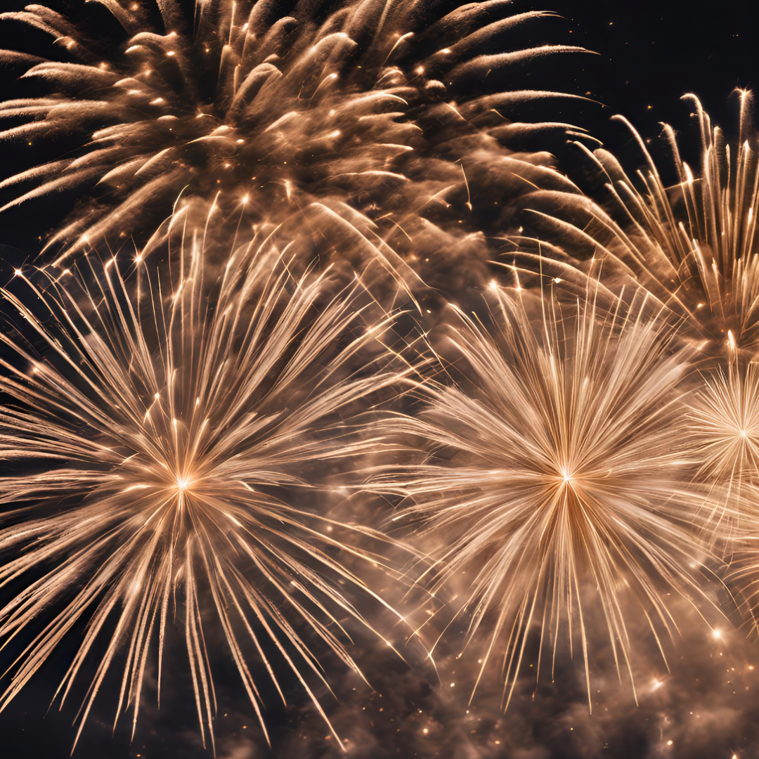 Fireworks exploding in the night sky with bright, golden streaks and trails.