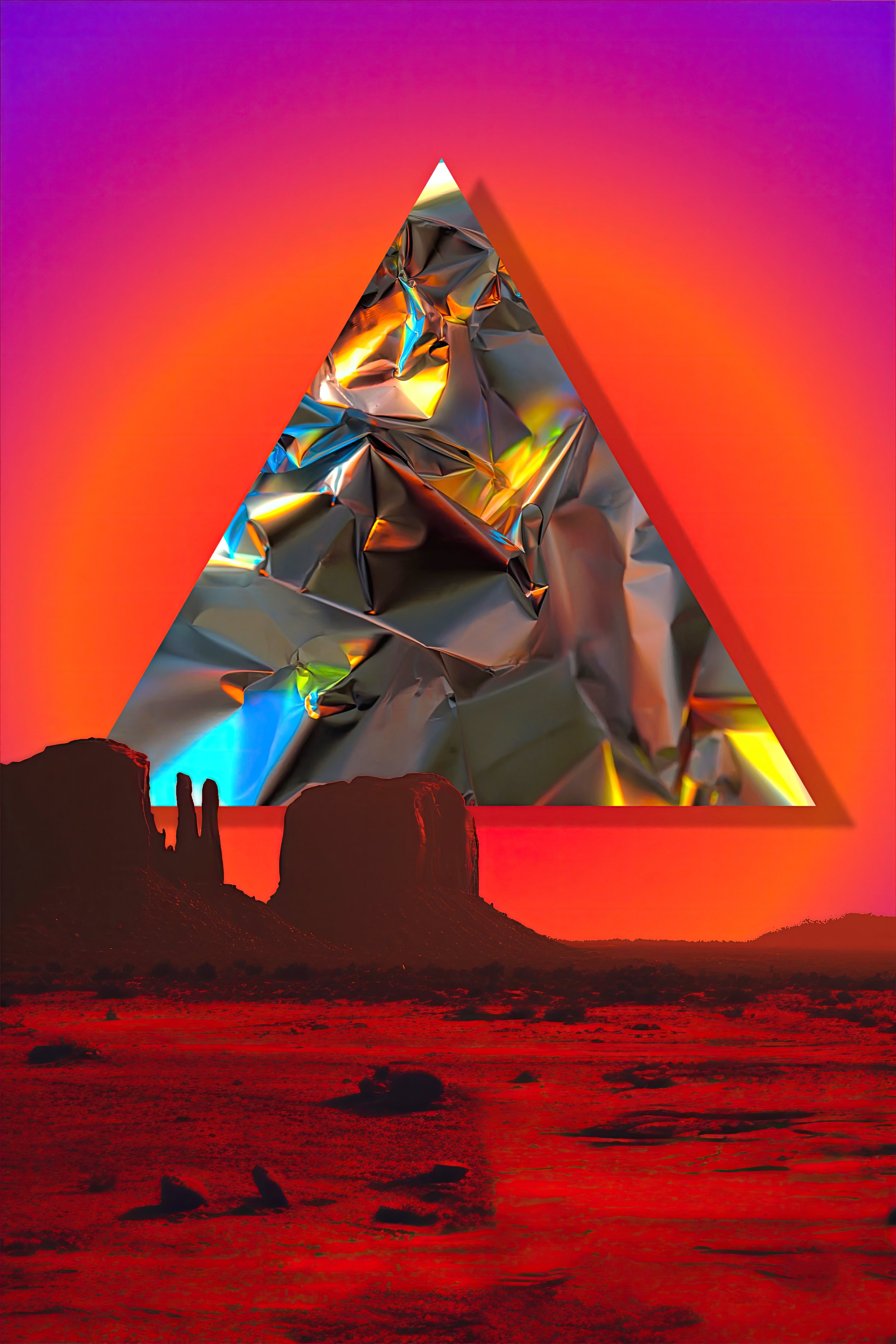 A surreal desert landscape with red ground and rock formations under a colorful gradient sky, featuring a large metallic, crumpled foil triangle in the sky.